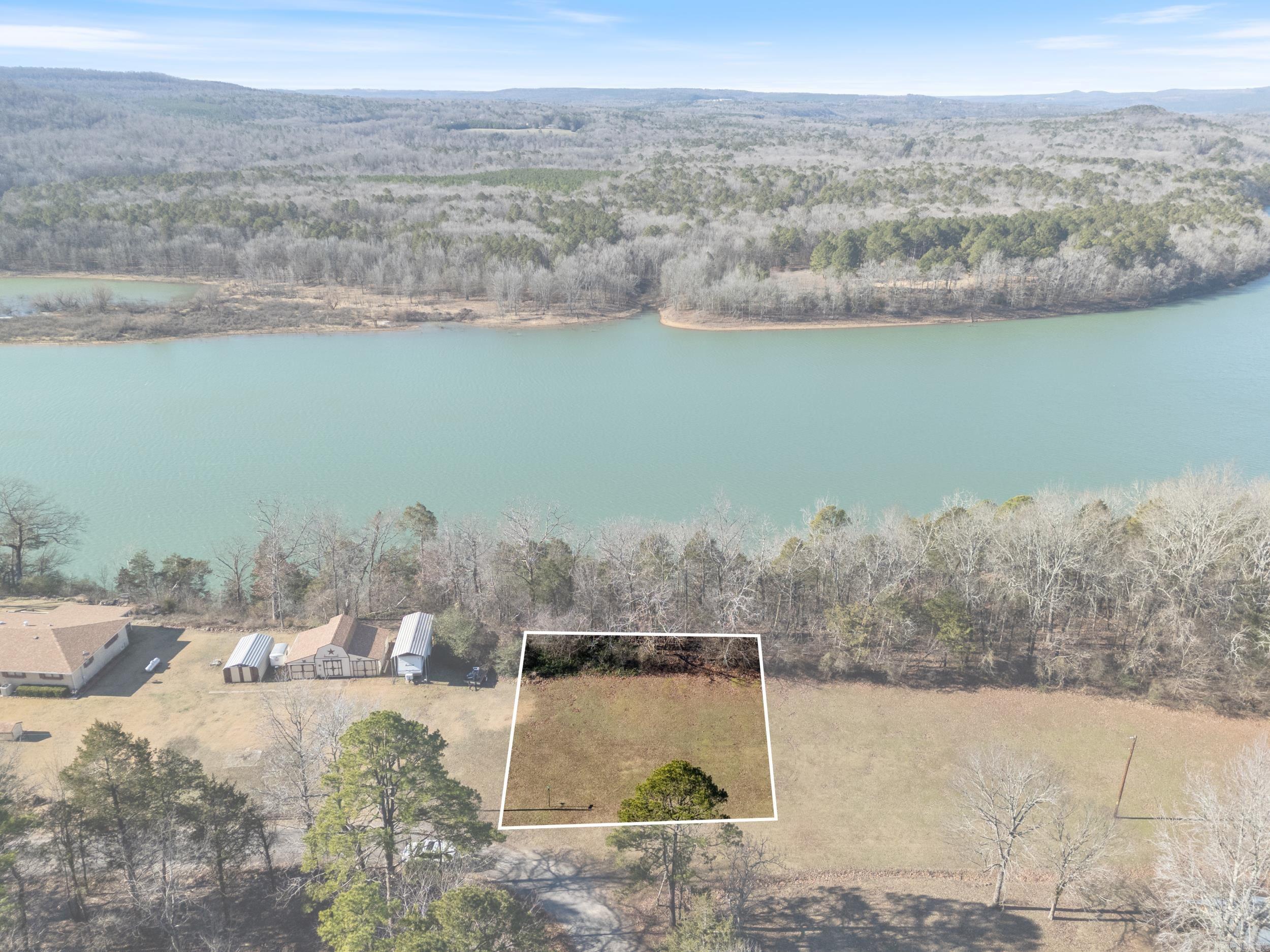 Discover your dream retreat with this stunning lake view lot in the serene Whispering Pines subdivision, overlooking the breathtaking Greers Ferry Lake. This .57-acre lot offers the perfect setting to build your custom cabin, surrounded by nature and featuring picturesque lakefront views. Additional lots are available for those seeking more space to expand your property. Utilities are conveniently located, making the building process smoother. Whispering Pines ensures a tranquil and well-maintained community, with no mobile homes allowed. Don’t miss this rare opportunity to own a piece of paradise and create the Lakeview getaway you’ve always envisioned. Contact us today to make it yours!