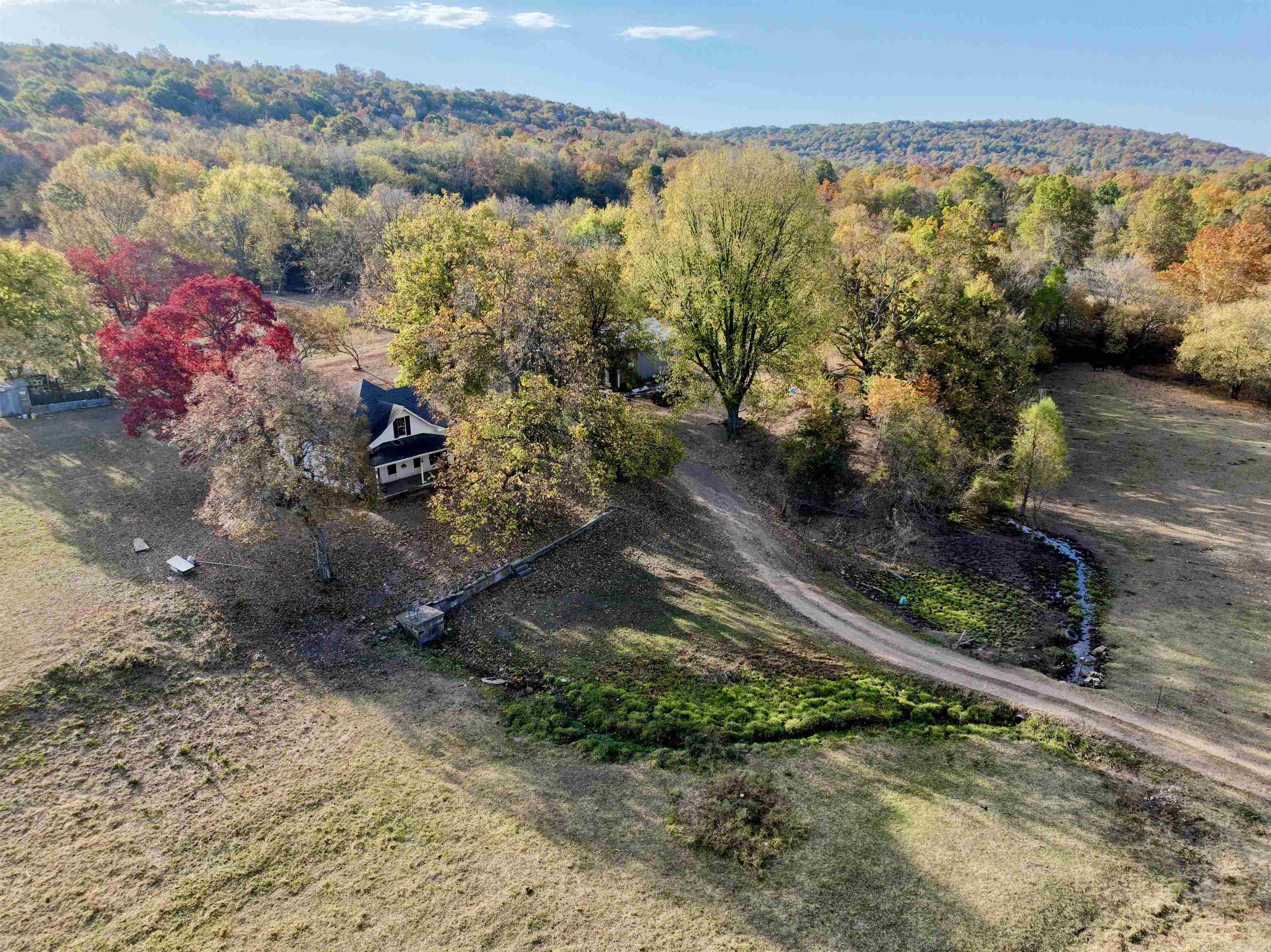 Welcome to this breathtaking Ozark farm nestled in a serene and picturesque setting, less than 50 minutes from Fayetteville. This exceptional cattle farm offers endless potential, making it a once-in-a-lifetime opportunity for buyers seeking rural real estate with investment appeal. Spanning several acres, this property is fully fenced and cross-fenced, providing an ideal environment for cattle operations and other agricultural pursuits. The landscape features a perfect blend of open pasture and hardwood timber, creating a diverse and functional environment. Numerous live springs are scattered throughout, offering year-round water resources, while a spring box and water well provide additional water supply. Electricity is already available on site, and there are multiple buildable locations where you can enjoy breathtaking panoramic views of the surrounding Ozark hills. Whether you're looking to construct a new residence or build cabins for recreational use, this farm offers ample options. There is also an old farmhouse that could be renovated to suit your needs, though it is currently valued only for its structure. Please use ShowingTime to schedule an appointment.