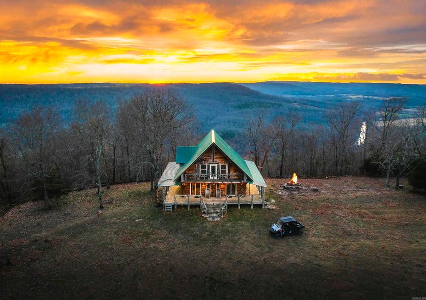 Stunning 167-acre property featuring a gorgeous log cabin with Douglas fir logs and red cedar interior walls and floors, 1 bed, 2 bath. Huge stone staircase, a stone fire pit, and a full wrap-around porch with breathtaking sunrise views across the 30-acre mountain top pasture known as Henderson Point. This pasture is right at a 1/2 mile long and was formerly a private airstrip. The back porch offers world-class sunset views over the middle fork of the Little Red River and the remainder of the property. Two stocked ponds with bass and bluegill, hunting opportunities for deer, turkey, and bear. Appliances stay. Some furniture and decor is slightly different than what’s pictured. 20-foot tall bluff. Plenty of room to build your dream home, plane hangar, or shop with the same stunning sunset views. Cabin is on rural water. Fiber internet is available.