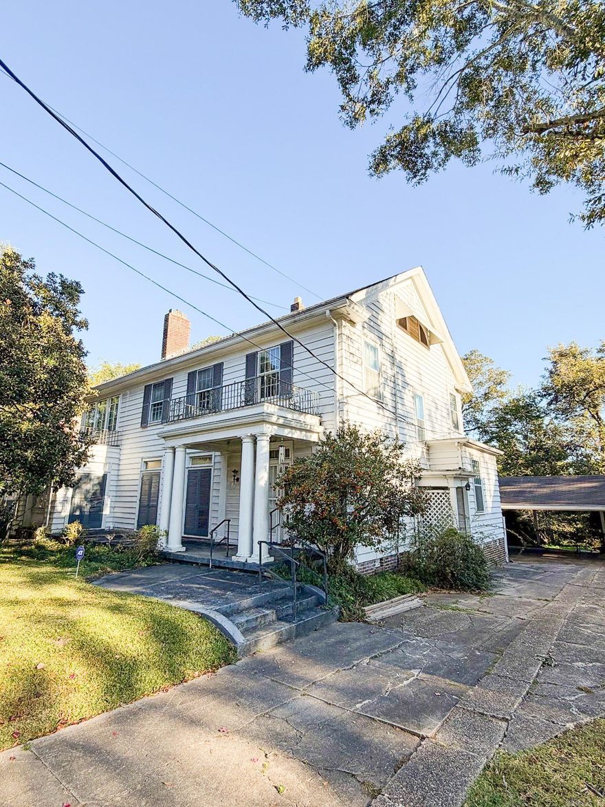 Step into a piece of El Dorado history! This grand, 100+ year old home offers incredible square footage, timeless character, and endless potential to make it your own. Located just minutes from Downtown El Dorado, this property combines historic charm with unbeatable convenience to shopping, dining, and entertainment.  The main level welcomes you with a generous foyer, large living area, dedicated office, formal dining room, spacious kitchen, and convenient half bath. Multiple covered porches and an uncovered patio create the perfect flow for outdoor living and entertaining.  On the second floor, you’ll find 4 bedrooms and 2 bathrooms. On the 3rd, there is an open space perfect for additional bedroom or playroom with a full bathroom. Two staircases and an elevator offer easy access throughout  A separate basement space, oversized garage, and additional carport provide incredible storage, workshop opportunities, or future expansion options.  With its original charm, abundant square footage, and flexible floor plan, this home is ready for its next chapter. Perfect for someone who loves character homes and wants the opportunity to breathe new life into a classic.