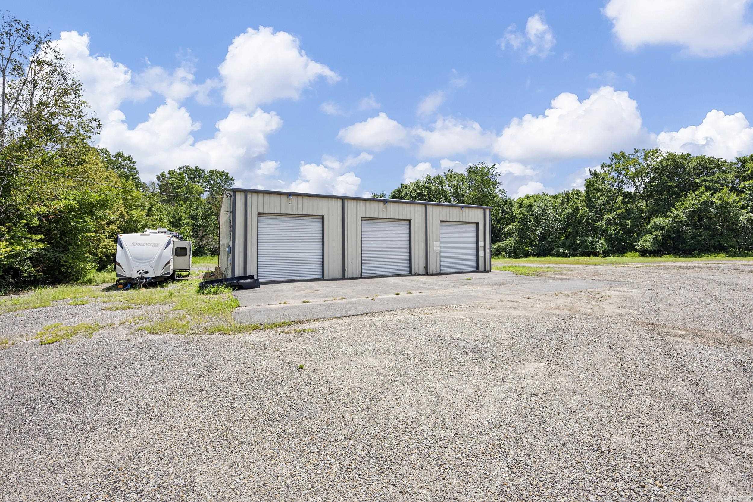 1031 Tax Exchange Opportunity! Currently leased with 2 separate tenants, Monthly Rent $4,700. This property includes 4.61 Acres and the sewer is running along the entire inside of this property for future expansions. The first building to the right as you enter is a Metal Shop 40 X 72 With roughly 800 Sqft that is office space. This building includes 4 Offices and 2 baths all heated and cooled by one Central Heat and Air unit. The second building to the left is a Metal Shop Newly built 60 X 40 with an Office, storage room and bathroom. This building includes 4 Roll up doors and a 12 Ton Car lift. Both buildings are setup with video cameras and full security around the property. This property is currently on one water meter and the water bill for both is paid by the seller.