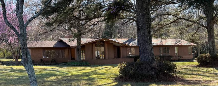 Set on 1.51 acres, this Prairie Style home, inspired by Frank Lloyd Wright, offers distinctive architecture and a peaceful setting.  The property also includes a 1,200 s/f ship building and presents excellent commercial or office potential.  Home is 3 bedroom, 2 baths and large bonus rooms that has access to the back porch.    Also available 6002 Becknell which is an adjoining 5.65 acres with 1,100 s/f rustic cabin with kitchen, bathroom and wood-burning fireplaces for $1,230,570.  Both properties can be purchased together for a discounted price of $1,950,000.