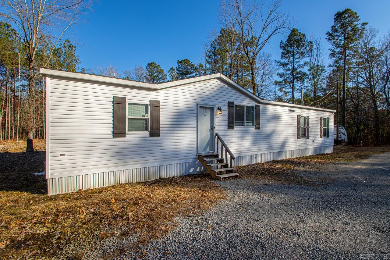 Looking for ACREAGE? Look no further. Approx. 7 Acres with a nice pond. There are fish in this pond. 3 bedroom 2 bath open floor plan with split bedroom plan.Cozy fireplace. Kitchen offers a nice island kitchen and plenty of cabinets. Also office area. Large laundry room. New back covered porch and area fenced in the back. Place to park an RV. New Storm shelter. New storage building. Lots of clearing out around the pond and wooded area so it is not so thick. This is a great property, very clean and off the road. BRING ALL ANIMALS! Lots of privacy. Schedule your showing today.