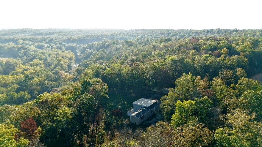 A rare combination of privacy, beauty and opportunity. Nestled down a well-traveled dirt road, this private 15-acre property offers a peaceful wooded setting with a stunning vista view. The land touches the Strawberry River, adding a unique natural feature, though direct access is currently limited.  The residence is a 2023 Clayton mobile home with a spacious addition, featuring three bedrooms and two bathrooms. Additional improvements include an RV carport, a storage shed, and a walk-in storm shelter for added safety and convenience.  This property combines natural beauty with functional living space, making it ideal for those seeking a quiet retreat or a full-time residence surrounded by nature.