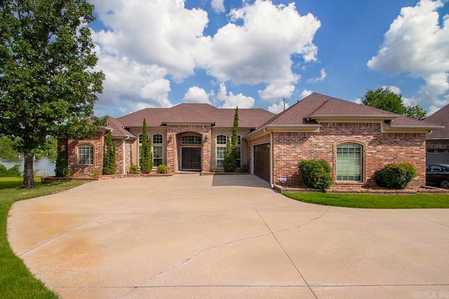 Unique find! This beautiful, custom home has a full view of Indianhead Lake, with water touching the back lot line all the way across the lot. Walk barefoot through the lush Zoysia grass lawn to enjoy sunsets and an expansive water view from the huge boat dock that conveys with this property.  Outdoor living is highlighted with an attached deck that's recently been redone with composite treads, (good longevity & no splinters!!).  Inside guests will be impressed with the tall ceilings and double front doors!  This home offers several additional spaces for privacy and function: an office, a sunroom and a sitting area in the primary bedroom, which would make a great work-out room, reading nook or nursery. This custom built, one owner home, is not only beautiful, but functions to suit many different family styles, with a split bedroom design, an open kitchen with upgraded professional appliances and a master suite that will make you 'never want to leave'!  You must see this home in person to appreciate all the upgrades, details and conveniences.  Schedule a showing today!!
