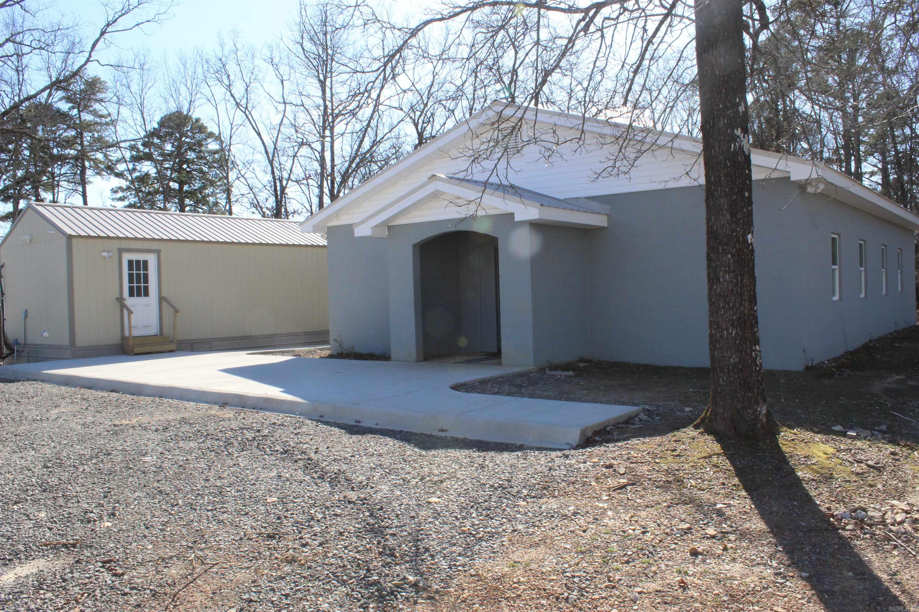 Business Potential Near Clinton, AR. A versatile commercial property, located just minutes from Clinton, AR, and the scenic Greers Ferry Lake, offers opportunities for business ventures. Six private bedrooms, providing comfortable accommodations. Common Area: Features two walk-in showers, two toilets with vanities, and washer and dryer hookups. Second building has a complete kitchen and dining area, suitable for communal meals or catering services. Also includes a full bathroom and two washer and dryer hookups, enhancing operational efficiency. Gravel parking lot accommodates ample vehicles, a patio area ideal for grilling and outdoor gatherings. 3 full RV hookups present an opportunity for additional income through short-term rentals or accommodating traveling professionals. Minutes from Clinton, AR ensuring convenience. Greers Ferry Lake: A renowned destination for fishing, boating, and recreational activities, attracting tourists year-round. This property's strategic location and diverse facilities position it as an excellent investment for various business endeavors, including hospitality services, recreational rentals, or communal gatherings. Mineral rights do not convey.