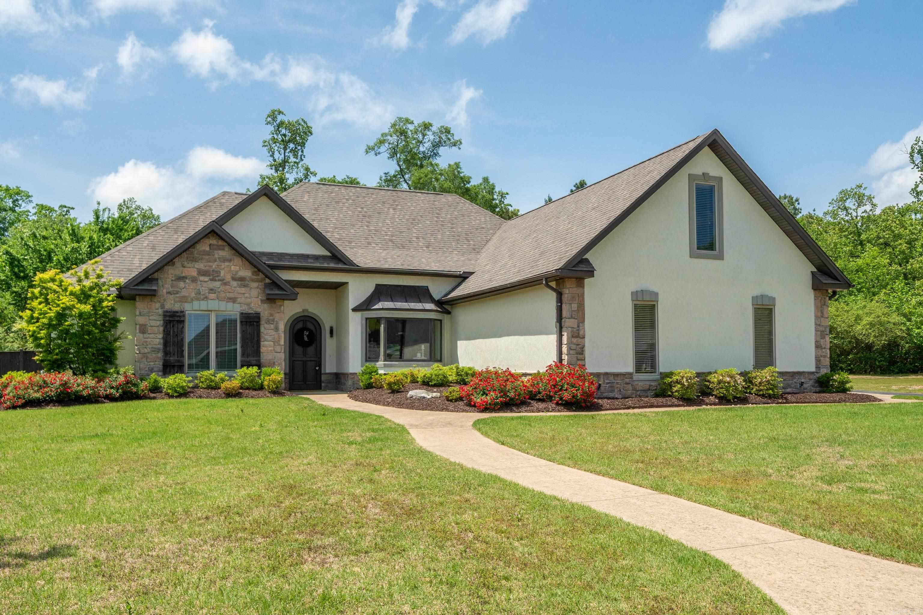 Stunning Custom Built 5 Bedroom 3 1/2 Bath Home in Gated Hunters Cove Phase III Subdivision - just off of Lake Hamilton. Beautiful Craftmanship await you throughout the open living & dining area. The kitchen boasts high end appliances, generous storage, and sleek countertops, making meal preparation a joy. Escape to the spacious primary suite which has two large walk-in closets, and custom finishes. Downstairs has two large guest bedrooms with Jack-N-Jill bathroom. A convenient half bath is located in the hall. Upstairs you will discover the Theater Room/Bonus Room, plus playroom/Extra living room two additional guest bedrooms with a full bathroom. Outside the home features include a quiet covered patio for entertaining, large fenced yard, beautiful landscaping, community boat storage lot, boat launch ramp and pavilion. Roof was replaced in 2024. For appointment, please contact Wayne Post, 501-454-8263
