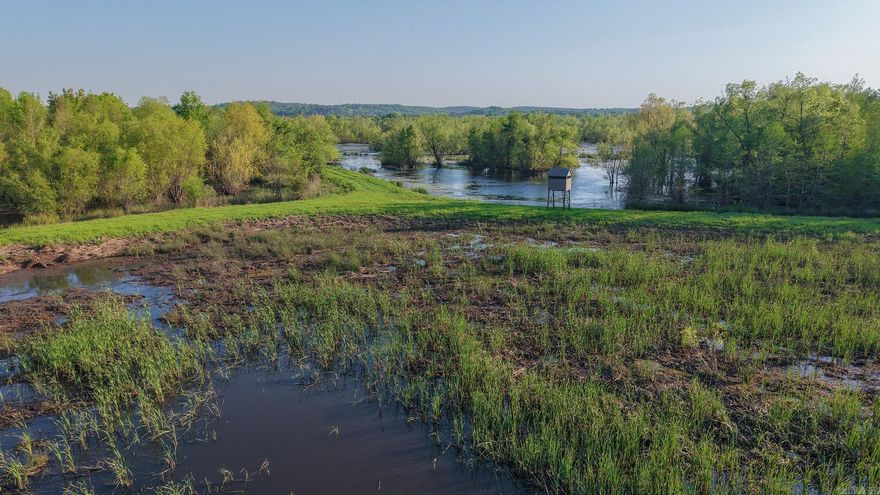Discover an incredible opportunity to own a premier deer and duck hunting property, perfectly set up for the serious outdoorsman. This property has been managed to create a thriving habitat that is rich with wildlife. The property is enrolled in the Wetlands Reserve Program (WRP) and surrounded by thousands of acres of similar habitat. From towering hardwoods and pines to lush bedding cover and native grasses, this well-developed wetlands make this a dream location for trophy whitetail and waterfowl hunting. A metal hunting cabin sits conveniently off the road, offering a comfortable place to relax after a full day in the field. The cabin is equipped with a large open entertaining and eating area, four bedrooms, and a large attached double garage, making it the perfect year-round base for family, friends, or a hunting club. There’s ample space to gather and store your hunting gear, plan your hunts, and tell stories after a successful hunt.