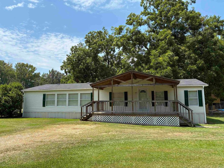 2005 1,680 sqft mobile home permanently affixed to a 0.38-acre corner lot. Immaculate condition. 3 bedroom / 2 bath, all electric. 2017 updates include paint and flooring throughout and remodeled primary bathroom. Large laundry room with side entrance. Beautiful 10x22 covered front porch. 2025 front storm door. Roof with gutters installed 2021. Original HVAC. Concrete slab patio.