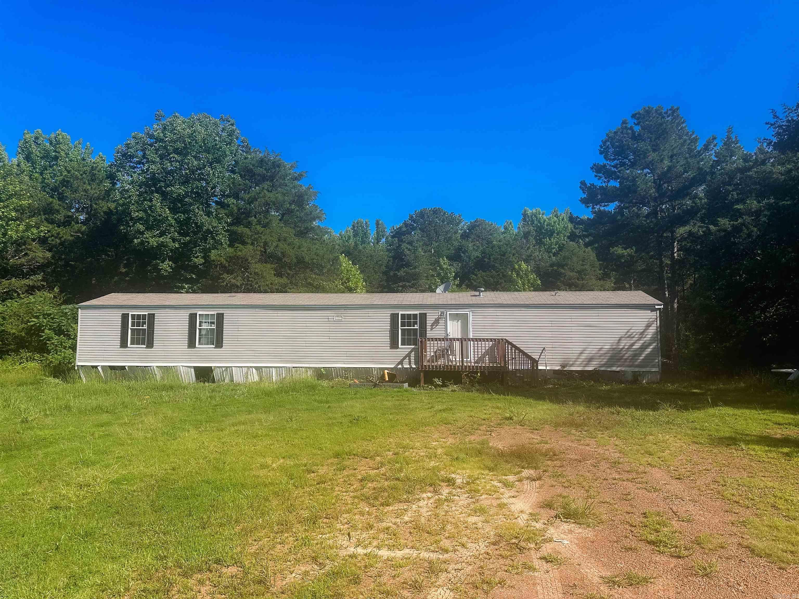 16 secluded acres with a 3 bedroom 2 bath mobile home! This property is just outside of town and within 15 minutes of Greenbrier & 5 minutes of Quitman. Mostly wooded acreage with a ton of potential! No restrictions, this property is ready for its new owners! Agents see remarks.