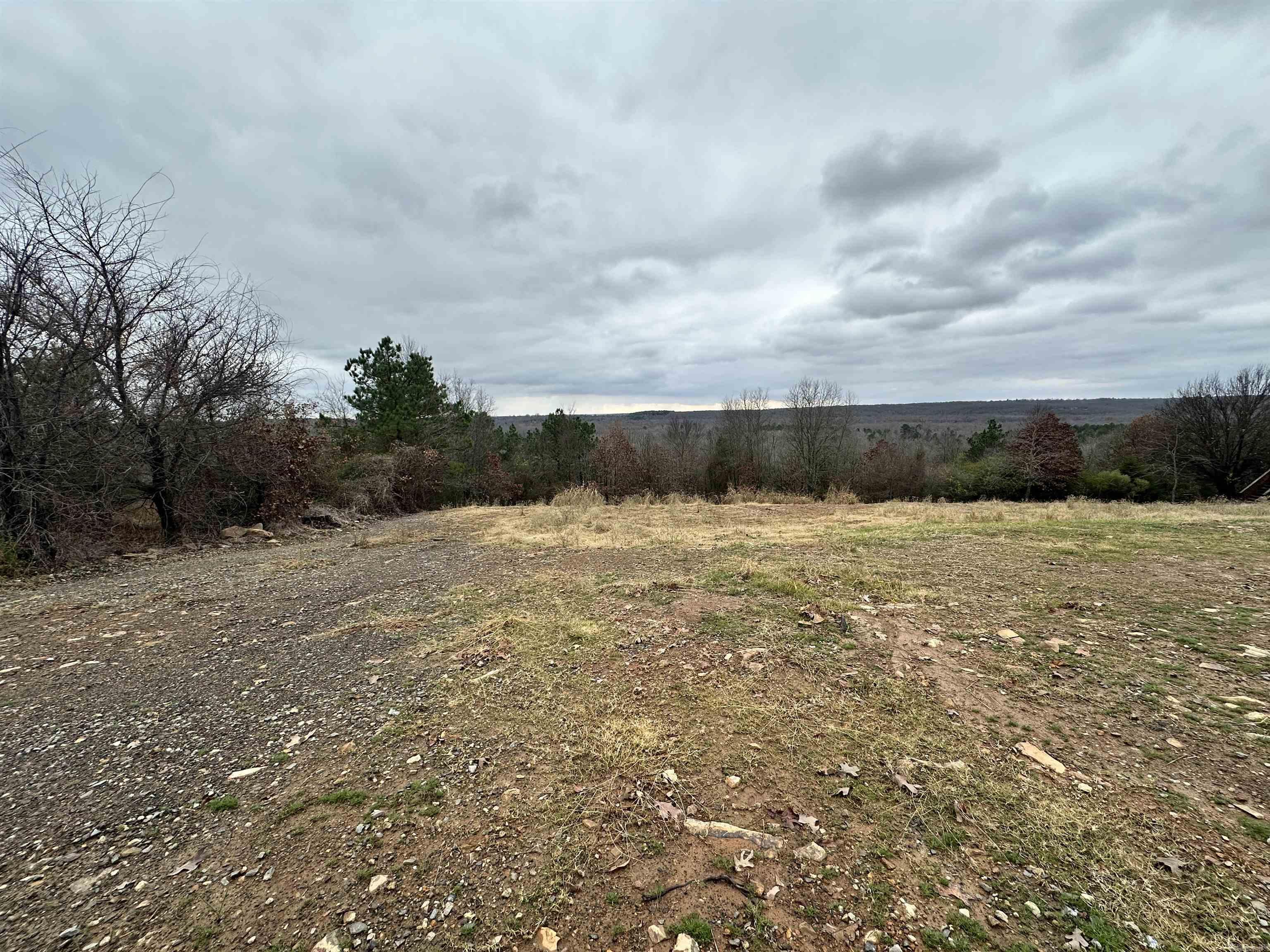 This lot offers unparalleled views of the surrounding hilltops and mountains. Whether you seek tranquility or a striking backdrop for entertaining guests, this hillside property delivers an exceptional living experience. Perched on a scenic hillside, this property allows you to feel as though you are on top of the world. Utilities are onsite and property is nestled between two homes.