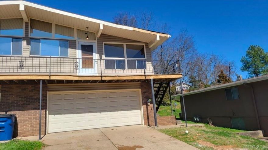 Step into this inviting 3-bedroom, 1-bath upstairs duplex unit, where warm wood tones and abundant natural light create a cozy cabin-like atmosphere. The full bathroom features a convenient bathtub and showerhead setup, offering comfort and functionality. The living room and dining area flow seamlessly into the galley-style kitchen, which provides generous counter space and ample cabinet storage for everyday cooking and meal prep. Hard-surface flooring throughout ensures easy maintenance. Enjoy the outdoors from your railed balcony, or take advantage of the front driveway and included garage - perfect for additional off-street parking or extra storage space. This unique home blends rustic appeal with practical modern living, offering a bright and comfortable space to settle into. •