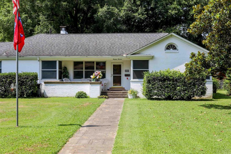 When you walk into this house you will step back in time to when homes were built with fine craftsmanship. This home was custom built and has so many beautiful custom touches. There are 3 bedrooms and 2 baths with 2 living areas, a dining room, and a sunroom.   Most of the home is covered in its original hardwood flooring. The sunroom has beautiful natural stone. There is crown molding and tall baseboards throughout the home that really make it a showstopper!   For the avid collector there are two walls lined with bookshelves in what could be a 3rd bedroom or den.   There is large bonus room off of the sunroom with newer vinyl flooring.  The vinyl windows don't detract from the homes original character.   You'll enjoy sitting on your covered front porch watching the world go by. This is a 1.25 acre corner lot. Entrance on W. Nettleton has an automated electric gate. There is a fenced backyard & small outside storage building.