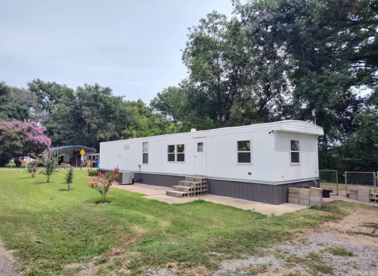 Charming 2-bedroom, 1-bath mobile home on a corner lot with canal access to Lake Conway! This home features a freshly painted interior, new flooring, and a brand-new roof. The fenced backyard offers a private space for outdoor enjoyment, and the mudroom with laundry hookups adds convenience. With a security system in place and lake access just steps away, this home is perfect for those seeking both comfort and recreation. Conveniently located just three minutes from I-40, 20 minutes to Little Rock, and 10 minutes to Sam's Club and Baptist Hospital in Conway. A great opportunity for affordable lake living!