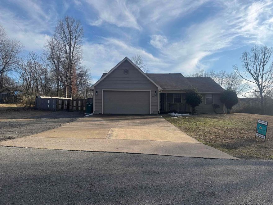 This inviting three-bedroom, two-and-a-half-bath double lot residence effortlessly combines comfort with style. Upon arrival, the home's curb appeal captivates with its manicured landscaping and welcoming facade. Inside, a thoughtfully designed open concept greets you, featuring a cozy den with 1/2 bath, ideal for both relaxation and productivity. The heart of the home centers around a spacious living area, perfect for gatherings or quiet evenings.  Venture outside, and you'll discover a generous backyard, providing an expansive canvas for outdoor activities. Additionally, the property boasts practical amenities, including a two-car garage, a two-car carport, a storage structure, catering to all your storage needs and an office space.  This residence elegantly combines functional spaces with charming details, offering a perfect balance for modern living. A perfect sanctuary for those seeking a blend of convenience and character in their next home.
