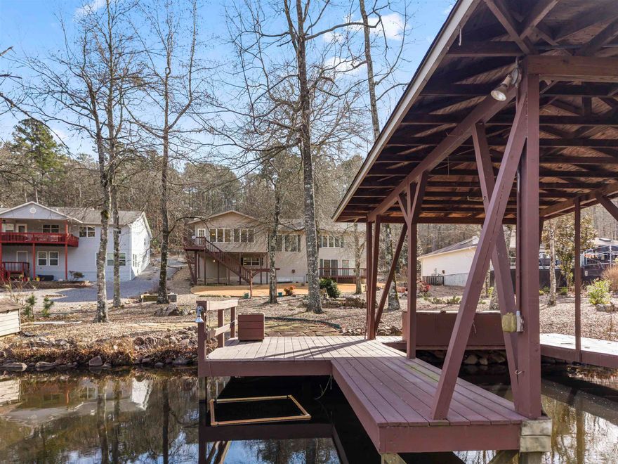 Lakeside Living at its best! This well maintained 3514 sq ft home on Lake Pineda boasts a Granite Island Kitchen, High Ceilings, Panoramic Lake Views including the Oversized Arkansas Room! The Bedrooms offer large closets, and the Lower Level with Full Bathroom is plumbed for a 2nd Kitchen, perfect for an extended family living situation or possible lock-out rental unit! The Covered Boat Dock is waiting for your boat! Energy efficient electric/propane Heat & Air keep this home comfortable all 4 seasons! The 26,000 gated acres of Hot Springs Village offers 11 Lakes & 9 Golf Courses, Tennis, Fitness Center, Indoor & Outdoor Pools, Miniature Golf, Performing Arts Center, Archery Range, Library, 13+ Restaurants, 24 Churches, 20+ Miles of Walking Trails, and Much More! DON"T MISS THE ATTACHED VIRTUAL TOUR!