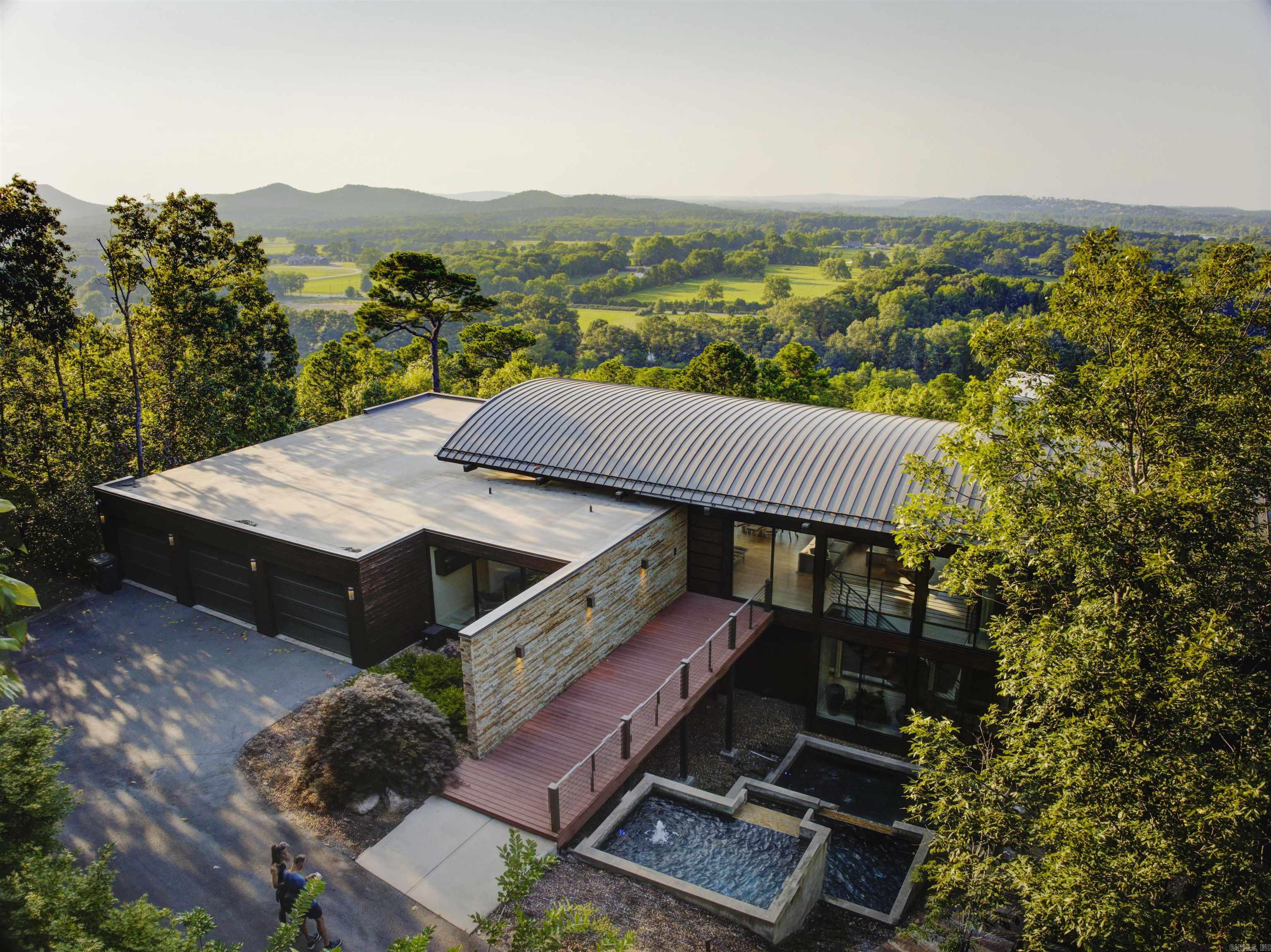 Welcome to an unparalleled living experience in the prestigious Beau Vue Estates Community of Little Rock, Arkansas. This exquisite residence, crafted in 2017 by the renowned Taggart Design and Build, effortlessly combines modern sophistication with timeless elegance. Set on over 5 acres, this home offers an exclusive escape with panoramic views that stretch as far as the eye can see. Step inside to discover a meticulously curated interior that features three spacious bedrooms, three full bathrooms, and two half baths. The impeccable architecture of this home is evident in every detail, from the expansive multi-level deck perfect for outdoor entertaining, to the two distinct living areas that provide ample space for relaxation and gatherings. The home also boasts a three-car garage, ensuring ample space for all your vehicles and storage needs. The custom furnishings, handpicked to complement the home's unique design, add an extra layer of luxury that cannot be replicated. This extraordinary property is more than just a home; it is a lifestyle. And, as an added benefit, the home is coming fully furnished, allowing you to move in and immediately enjoy the luxurious surroundings.