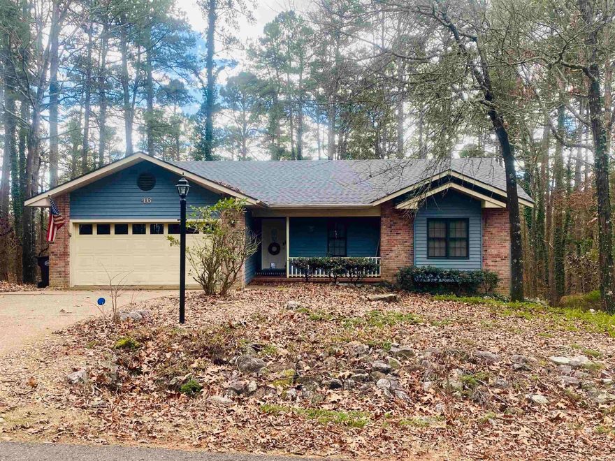 Welcome to 46 Dominar Way, a charming 3-bedroom, 2-bathroom home in the heart of Hot Springs Village. This 1,933 sq. ft. retreat offers a bright and spacious sunroom with vaulted ceilings, a cozy fireplace, and panoramic views of the lush surroundings. The home features a bonus room and a large workshop with outdoor access, perfect for hobbies or extra storage.  The kitchen includes an electric range and plenty of counter space, while comfortable flooring throughout combines carpet, tile, and laminate. A heat pump system ensures year-round comfort.  Outside, the 0.25-acre lot boasts a level driveway, 2-car garage, and a covered porch for relaxing or entertaining. The home’s low-maintenance brick and vinyl siding complement its timeless appeal.  Situated in the Balboa Golf Course neighborhood, you'll enjoy world-class amenities, including golf courses, pools, trails, tennis courts, and a marina, all within a secure, gated community.  This delightful property offers the perfect balance of comfort, convenience, and leisure. Schedule your showing today and experience the lifestyle you deserve!