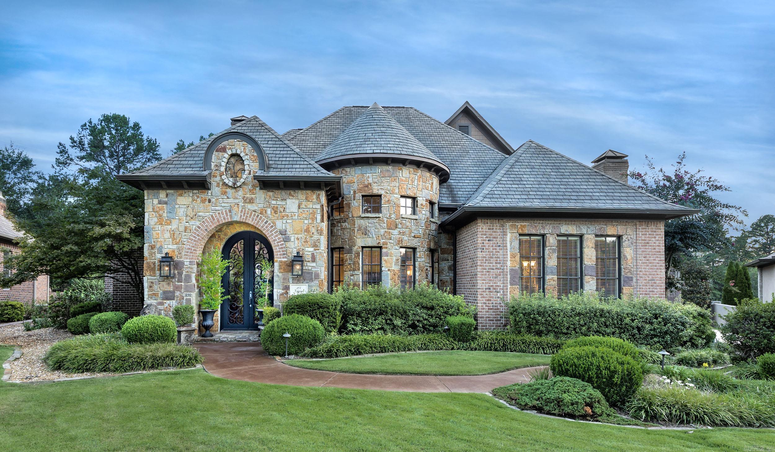 This stunning home is designed for both entertaining and effortless living. A spectacular two-story entry opens into the formal living room, where walls of windows overlook a gorgeous in-ground pool, tranquil water feature, outdoor fireplace, and a large covered patio. The private, level backyard creates the perfect backdrop for gatherings of any size. The spacious den connects seamlessly to the eat-in kitchen, featuring two pantries, a Viking 6-burner cooktop, wall ovens, a cozy fireplace, bar, icemaker, and wine refrigerator—everything needed for cooking and entertaining in style. On the main level, you’ll find the luxurious primary suite, a guest bedroom, home office, formal living and dining rooms, 2.5 baths, and a full laundry. Upstairs offers even more space with a media room, additional bedroom, and full bath. Located in The Arbors, a gated neighborhood where all lawn maintenance is included, this home offers convenience as well as beauty. With easy access to the country club and all the amenities of Chenal Valley, this property combines privacy, elegance, and lifestyle in one remarkable package.