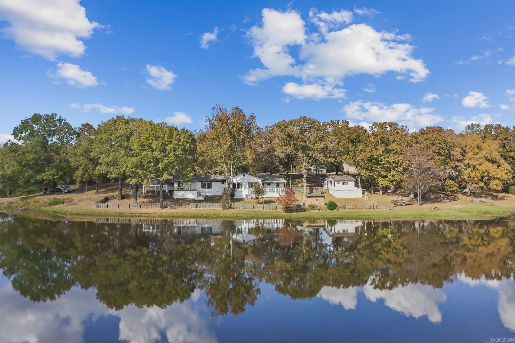 Discover the perfect blend of tranquility and convenience at this stunning lakefront property, uniquely set on multiple lots with expansive views of the water from nearly every window in the back of the home. Built in 1990, this spacious residence offers a rare layout that includes master bedrooms on each side, providing both privacy and comfort. Ideal for those who love both relaxation and functionality, the property features a beautiful sitting deck where you can unwind, enjoy serene lake views, or entertain guests against a stunning natural backdrop. One of the home's standout features is the large, versatile shop, perfect for hobbyists, additional storage, or creative projects. Imagine waking up each day to picturesque water views, sipping your coffee on the deck, and experiencing the peaceful ambiance that only lakefront living can offer. Whether youāre seeking a year-round home or a weekend retreat, this property promises a lifestyle of relaxation, beauty, and utility. With its thoughtful layout, abundant space, and breathtaking surroundings, don't miss the opportunity to make this lakeside haven your own. Schedule your personal showing today.