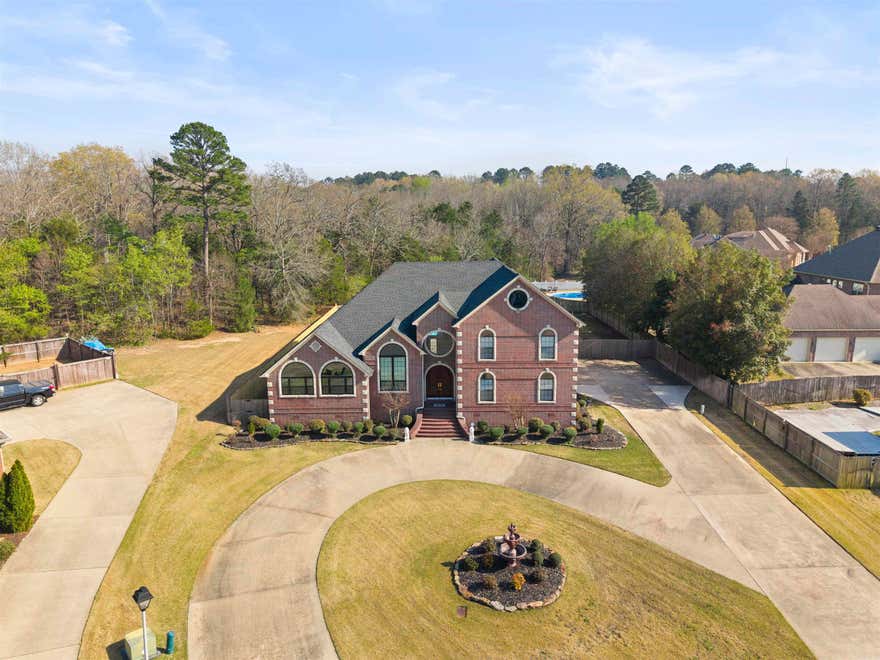 One owner Custom-built home by Bobby Wooten offering approximately 4,695 sq ft of living space.This home features 6 bedrooms  and 4.5 bathrooms. The living room features a 23-foot vaulted ceiling, skylights, gas log fireplace, and built-in cabinetry. The kitchen, living, and dining areas are connected with an open design and include a new stove and microwave. The owner’s suite includes a walk-in closet, built-in storage, jacuzzi tub, and walk-in shower. A guest suite features a vaulted ceiling and jacuzzi tub. Upstairs includes a large game room and third-floor loft, providing additional space for a variety of uses. Exterior features include a 16x24 in-ground pool with a Hayward automatic cleaning system, and a 10x10 pool house with bathroom and outdoor shower.