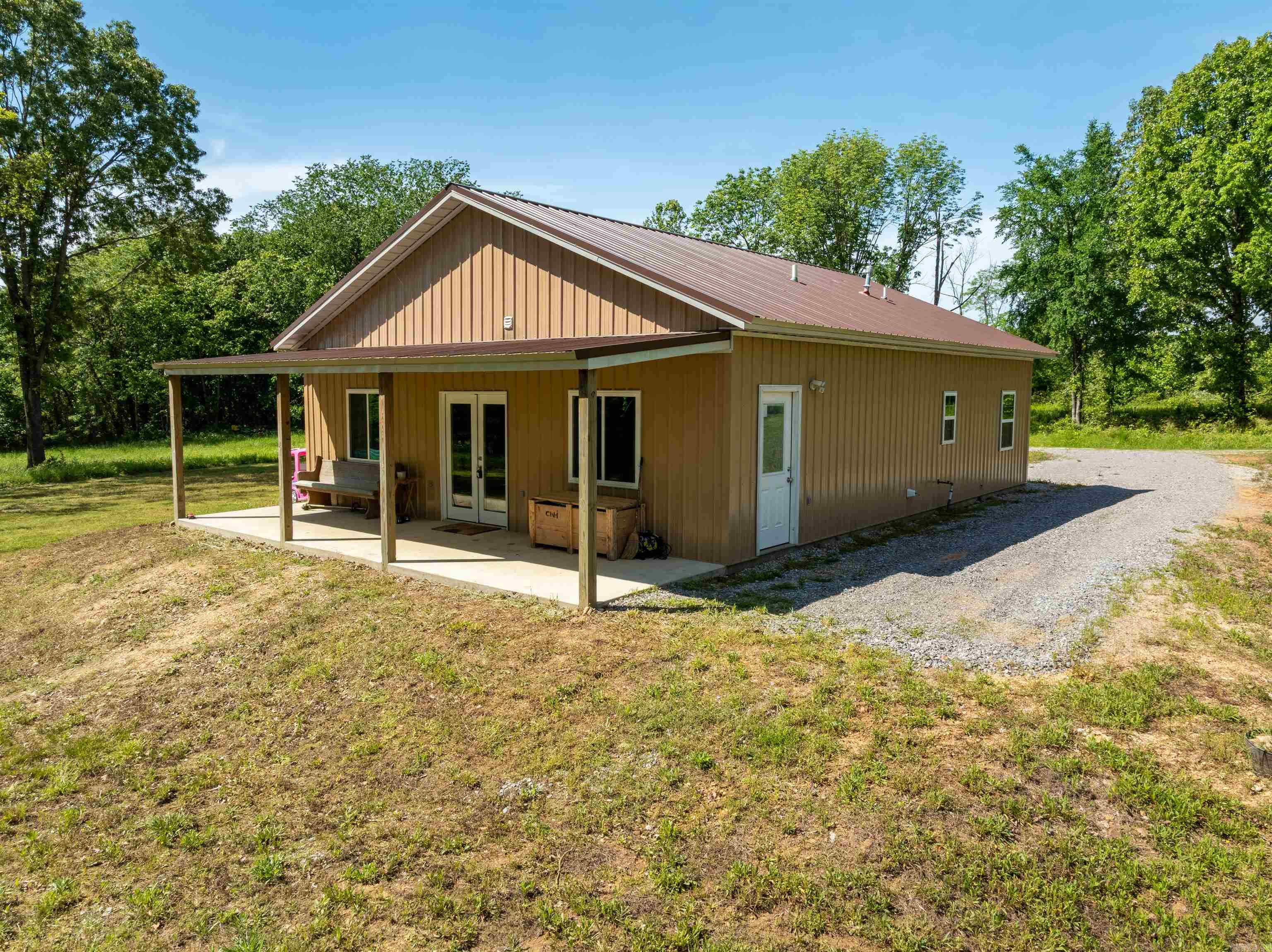 Newly built in 2021, this barndominium-style home sits on just over 1 acre, ideally located just north of Cave City. Featuring 2 bedrooms and 2 bathrooms, the home offers an open floor plan that makes the 1,200 square feet feel spacious and inviting. The large primary suite includes a generous en suite bathroom for added comfort and privacy. While conveniently located off Highway 167, the home is set far enough back to provide peace and quiet, with no view of passing traffic. A deeded driveway ensures easy access. Just minutes from both Cave City and Ash Flat, this property offers the perfect balance of rural charm and accessibility.
