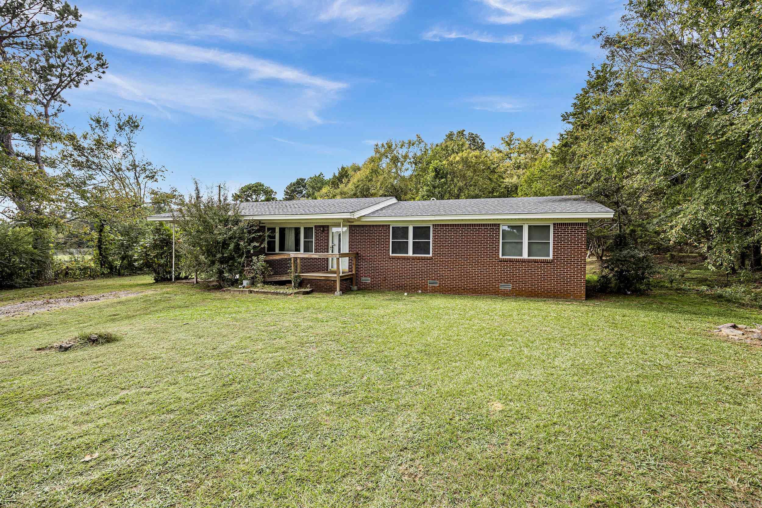 This home is perfectly located just one mile from I-40 at Morrilton. Enjoy the best of both worlds - out of the city limits but minutes to Walmart! AND it's a great place to have a yard sale! Beautiful original hardwood floors and quaint and cozy eat-in kitchen with bar stool seating. Refrigerator, washer, dryer, microwave and freezer to convey to buyer at closing with no warranty on condition. Seller discloses that Portable dishwasher does not work. New Terminex bait stations just installed with new contract. Home is hard wired for alarm system. Roof is about 5 years old, Energy efficient windows were installed 10-12 years ago. Whole house Generac generator was added in 2021. Propane tank is rented and services furnace, water heater and backup wall heater. Mineral rights do not convey.