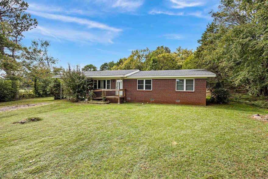 This home is perfectly located just one mile from I-40 at Morrilton.  Enjoy the best of both worlds - out of the city limits but minutes to Walmart!  AND it's a great place to have a yard sale!  Beautiful original hardwood floors and quaint and cozy eat-in kitchen with bar stool seating.  Refrigerator, washer, dryer, microwave and freezer to convey to buyer at closing with no warranty on condition.  Seller discloses that Portable dishwasher does not work.  New Terminex bait stations just installed with new contract.  Home is hard wired for alarm system.  Roof is about 5 years old, Energy efficient windows were installed 10-12 years ago.  Whole house Generac generator was added in 2021.  Propane tank is rented and services furnace, water heater and backup wall heater.  Mineral rights do not convey.
