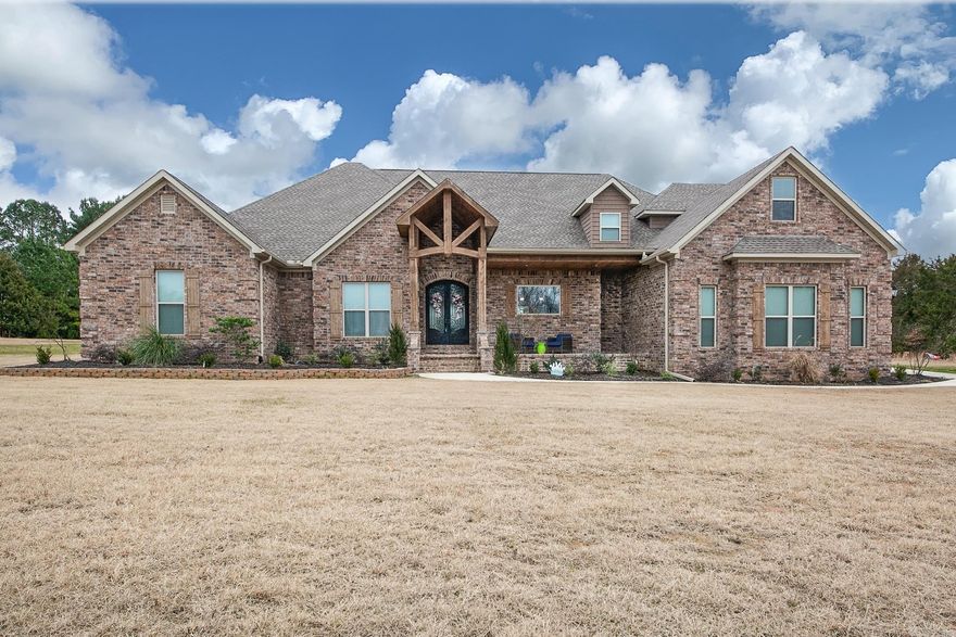 This stunning custom home, nestled on over six acres, offers an exquisite blend of luxury and comfort with all the modern upgrades you desire. The main house, an all-brick masterpiece, features four bedrooms, three and a half baths, and captivating beam work throughout. Enjoy the elegance of luxury vinyl plank flooring and a living room adorned with a beautiful tile fireplace. The kitchen is a chef's dream with a double wall oven and a massive pantry, while the bar area beckons for entertaining. The spacious master bedroom includes an adjoining room perfect for a private retreat or home office. Step outside to relax by the inviting in-ground pool, complete with a pool house that boasts a fully equipped kitchen, a bedroom, and one and a half baths—ideal for guests or as a serene getaway. This home truly embodies the perfect balance of sophistication and functionality.