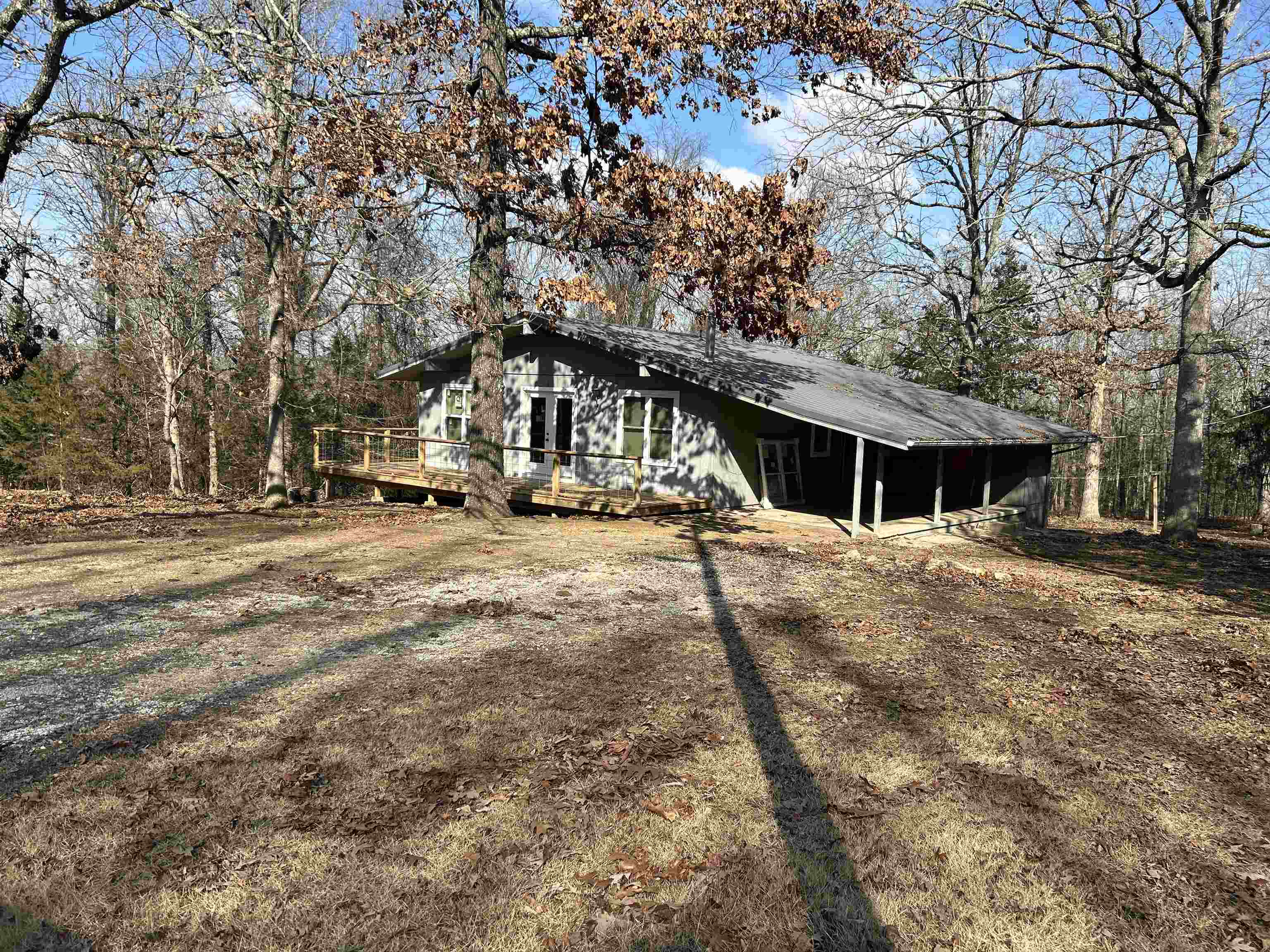 Cute holiday style cabin with end of the road privacy. Level lot that is cleared. Woods surround the lot. Newer metal roof.  New HVAC, windows and deck. Some new flooring in home. There is a walk in crawl space for storage under house and deck on back and front. This would make a great weekend home or VRBO.  Great for first time home buyer or retired couple. Peaceful and quiet area and close to town center and amenities that include Crown Lake and Turkey Mt Golf Course.