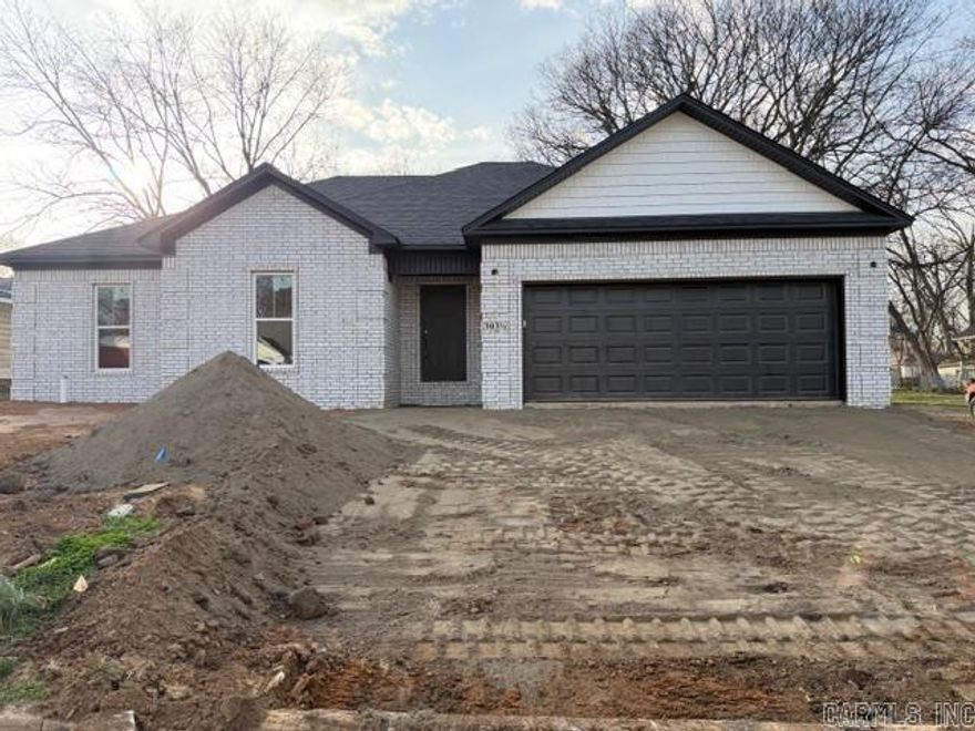 Quality New Construction by Hobbs Construction in Morrilton! This all-brick home offers standout curb appeal with its light brick exterior, dark architectural accents, and spacious two-car garage. Step inside to a bright, open living area featuring durable luxury vinyl plank flooring, recessed lighting, and clean, modern finishes throughout. The kitchen is designed for both style and function, showcasing quartz countertops, white shaker cabinetry, classic subway tile backsplash, and stainless appliances. The thoughtful split floor plan provides privacy, while the primary suite features a double vanity and walk in shower. With quality craftsmanship and a desirable location in the heart of Morrilton, this home combines comfort, style, and everyday convenience. Don’t miss your opportunity to make it yours!