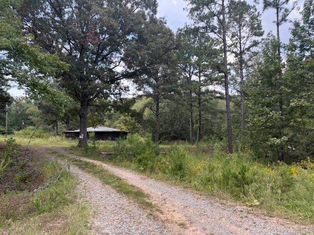 Investor Opportunity & needs Refurbished! Mobile Home on 1.15 Acres. Property Sold AS IS! 3 Bedroom, 2 Bath Double-Wide Mobile Home with Nice Floor Plan! Wrap Around Screened in Porch and Metal Roof. Storage Building. The Church property next door is also on the market with 3 acres and would be a nice Add-on to have a home and Business! Agents, SEE REMARKS!