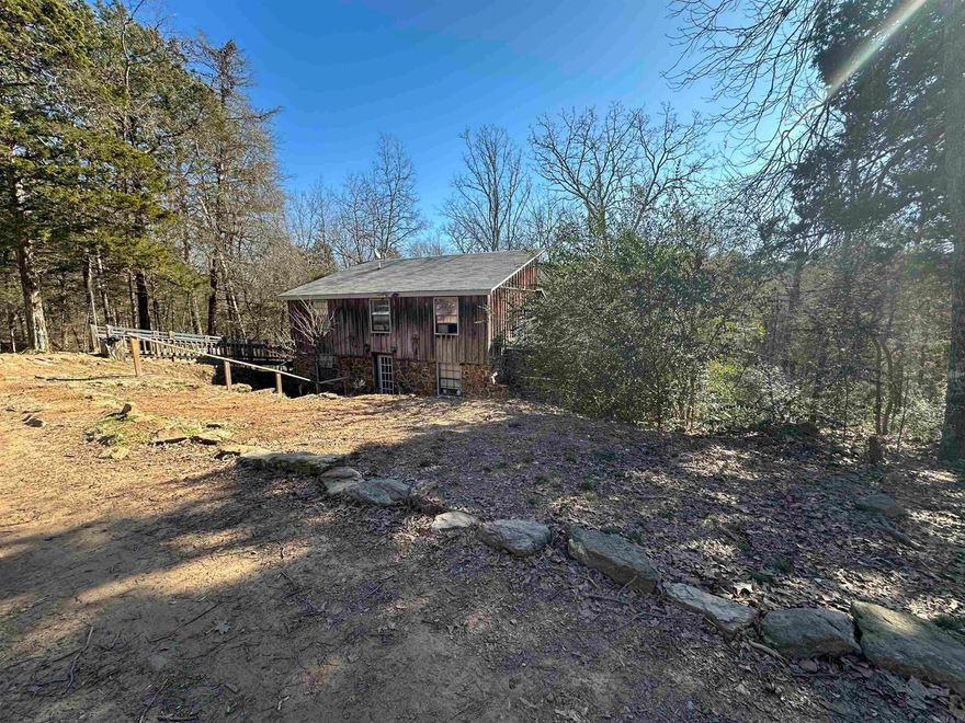 Have you been looking for a home to homestead and the ability to work remotely? From wet weather creek, fruit trees, berry bushes, and many more possibilities.  Large back deck to entertain, grill or just kickback and relax. Primary bedroom on main level, 2 bedroom and a bonus room/office upstairs with full bathroom. 24x30 shop and 10x16 outbuilding/chicken coop. Large laundry room/pantry. Man cave under the house also used as safe room with natural rock that gives a little extra charm. All this sitting on 5 Acres M/L. Call today for your viewing appointment. Let's make it yours. Agents see remarks.