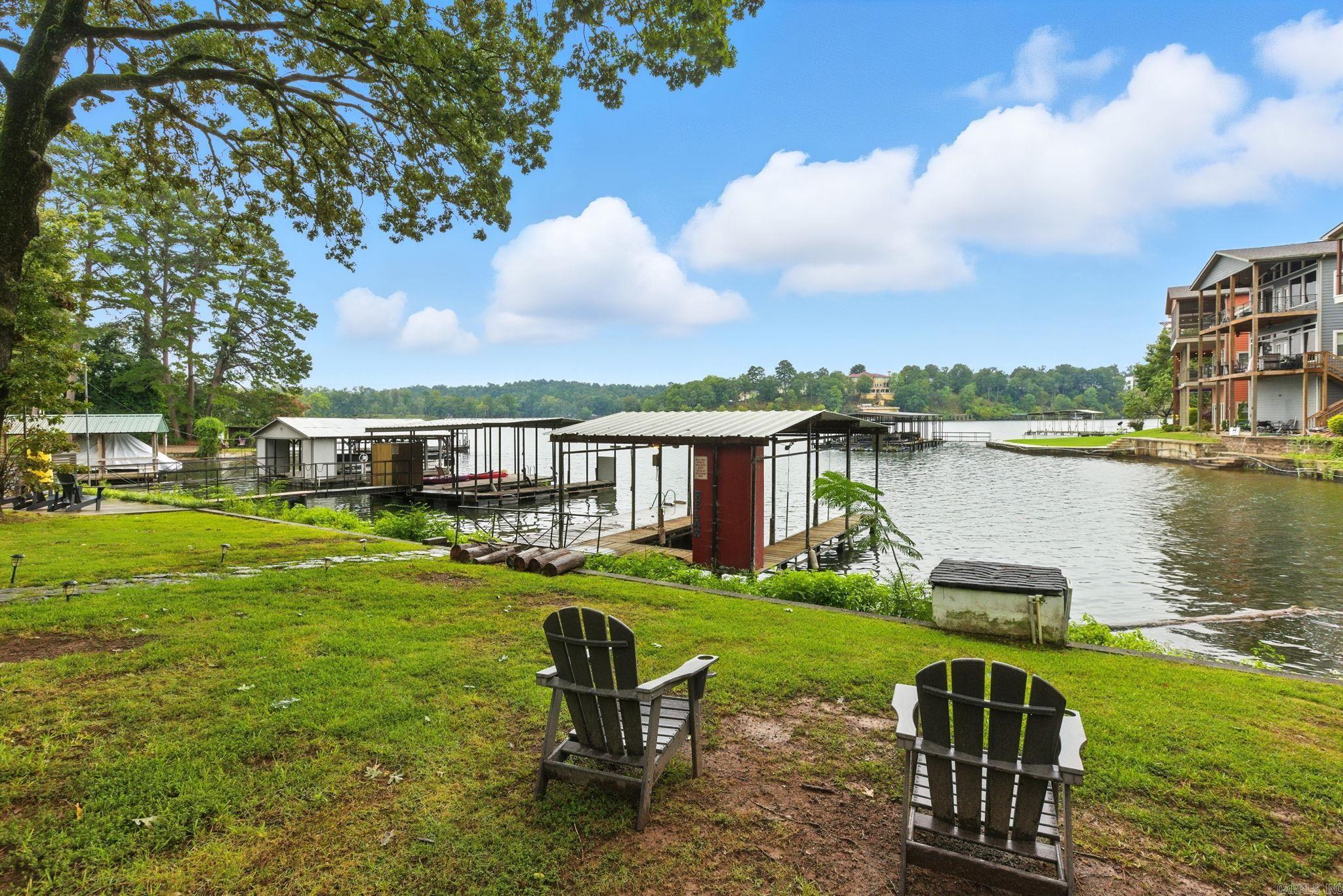Don't miss out on this 2 for 1 opportunity! Enjoy the serenity of your waterfront retreat while earning passive income! The cozy cottage offers a 2 bedroom and 1 bath. The back patio has a great hot tub that will convey, the patio leads down to the private boat dock with a brand new lift! It boast nearly an acre of land and 100 feet of lake front access with amazing views. The loft is entirely separate. It was added in 2000. Could be used as a second rental or mother-n-law quarters. It will be yours to decide. It has 2 bedrooms, 2 bathrooms, and a cozy family space. The upper deck, has an amazing view of Lake Hamilton, and below is a covered patio with a relaxing hot tub to convey! Don't miss this opportunity. This Lake Front Resort is being sold fully FURNISHED!