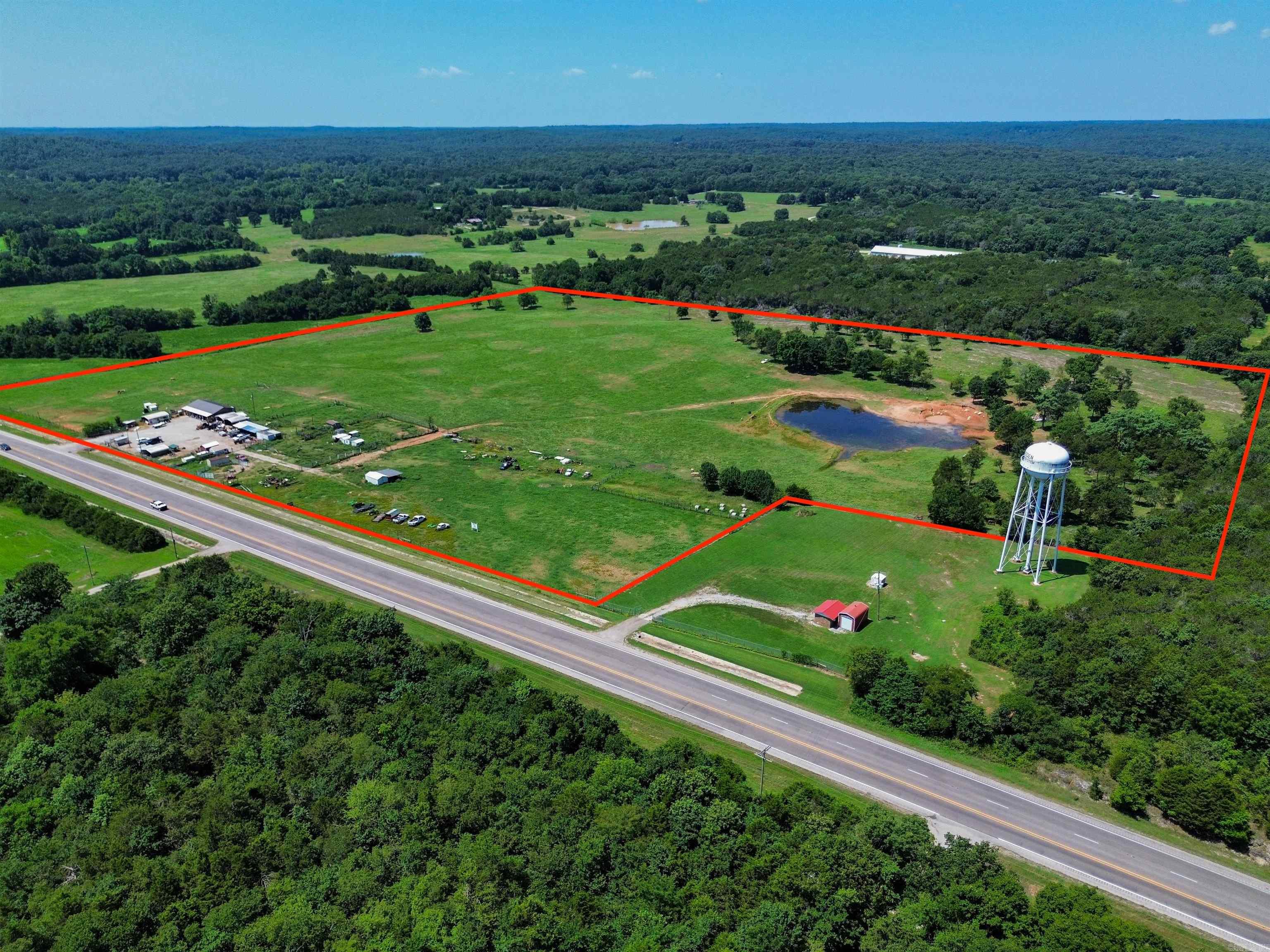 Nestled just a mile from the Imboden city limits, this expansive 34.83-acre property in Black Rock, Arkansas offers an ideal mix of country living and business potential, with over 1,100 feet of Highway 63 frontage. Perfect for those seeking space, versatility, and tranquility, this property is ready for whatever you envision. The charming 1080 sq. ft. home features cozy living spaces and a large covered front porch perfect for relaxing or spending time with friends and family! Whether youāre looking for a place to call home, or a future project to expand upon, the possibilities are endless. The land itself is fully fenced and cross-fenced, making it ideal for cattle and other livestock, with lush pasture and a large pond. Numerous outbuildings provide ample storage and workspace, whether you plan to run a farm or a business. With its prime location and Highway 63 frontage, this property offers incredible potential for developmentābe it a farm, event venue, gas station, car lot, or shopping complex. The skyās the limit! This is a rare opportunity to own a property that blends rural charm with fantastic development possibilities. Schedule a tour today! (Lot drawing pictured approx.)
