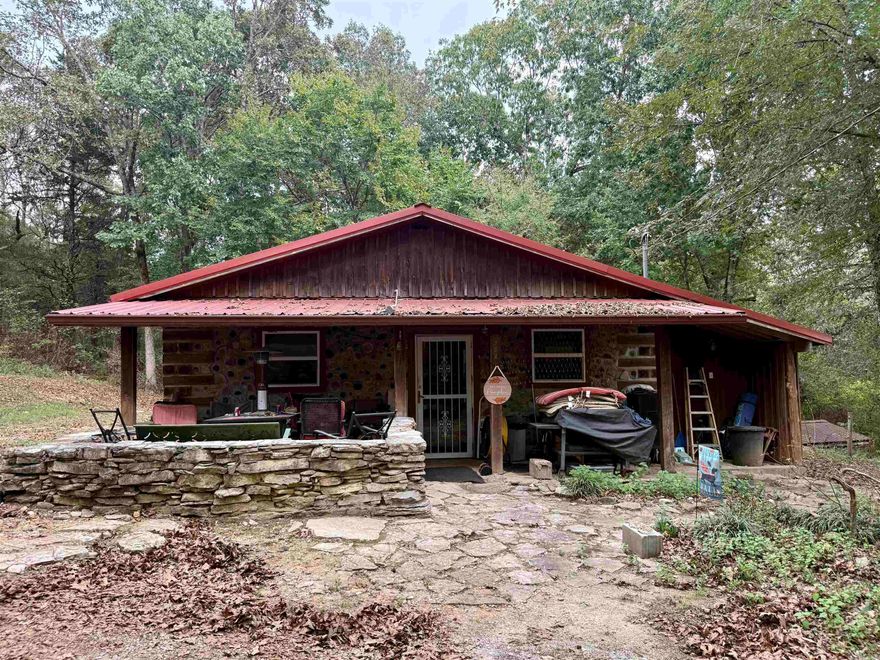 Escape to your own rustic retreat on 20 beautiful acres! This handcrafted Cedar Cordwood-style home exudes character with 16'' exterior walls and walkways made from rocks harvested right off the land. Inside, you'll find 2-3 bedrooms, 2 baths, an Amish-built kitchen, rock and laminate flooring, wood heat stove, and Senville mini-split units (2024). Outside offers space to breathe with a -acre pond, storm/root/wine cellar, 20x30 wired shop with deck, 18x20 guest house with kitchenette, storage building, and more. Roof replaced 2019/2020, propane tank leased and filled Aug 2025, and Clay Co Connect fiber internet available. Refrigerator stays, and home will be professionally cleaned after move-out. A true blend of craftsmanship, comfort, and country serenity!