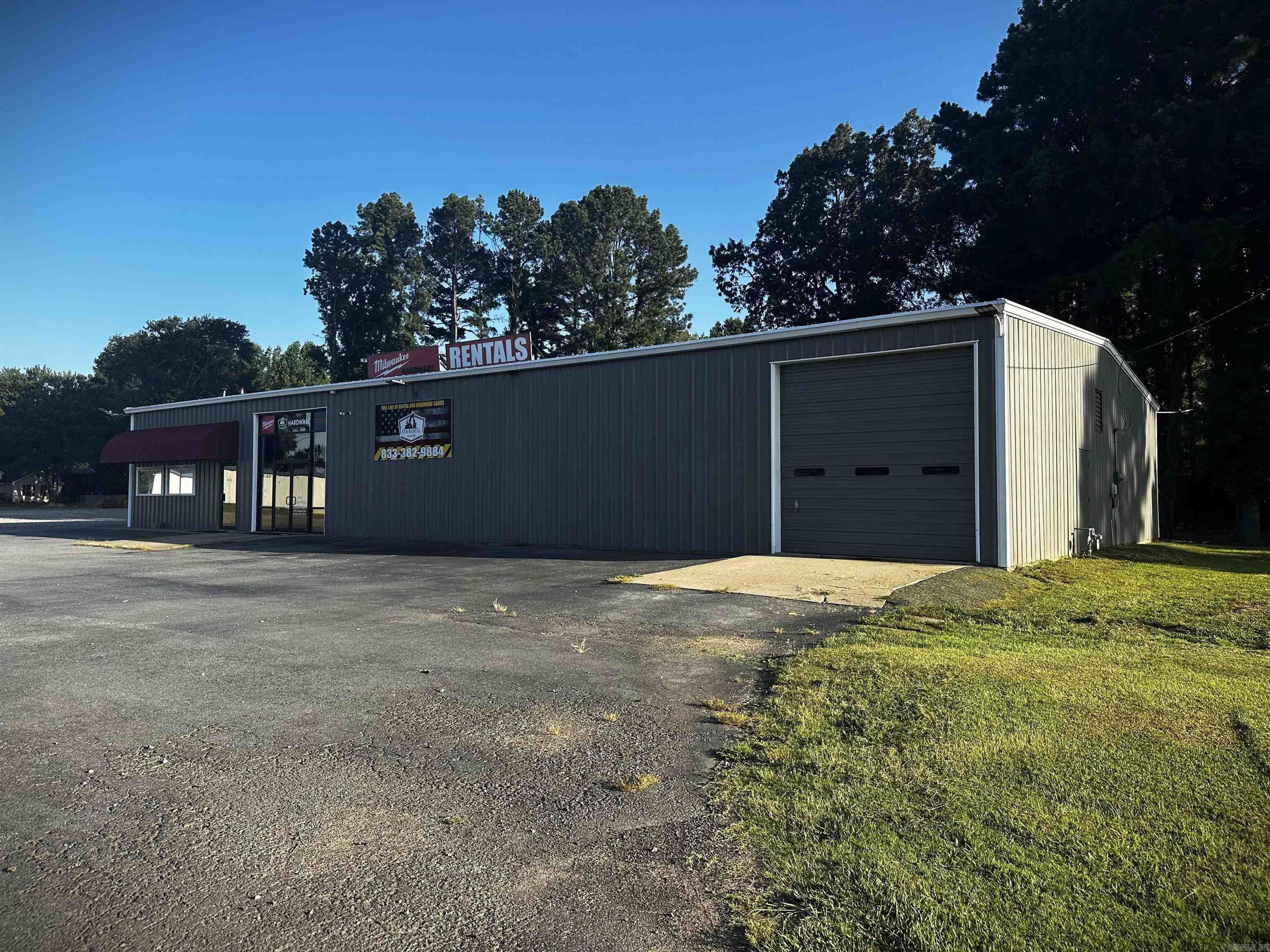 Located just off of I-57 on the busy Exit 28/Hwy 64 intersection. This versatile 6,000 sqft. commercial property offers 4,200 sqft. of heated/cooled space and 1,800 sqft. of additional warehouse space, situated on a 1.28-acre lot zoned C2. Renovated in 2024 and currently operating as a tool retail store, equipment rental business, and equipment repair shop, it presents a turnkey opportunity for business owners. Highlights include a 33' x 23' showroom with glass-front double-door entry and a modern 20' x 12' office with full glass wall. Two mini splits provide comfort for both areas. An existing office on the opposite side of the showroom allows for two to three private office configurations, a breakroom/kitchen and dedicated restroom. The heated/cooled shop area spans approx. 2,500 sqft. and features two large bay doors with garage door openers, a loft, bathroom, and ample storage. The separate 1,800 sq. ft. warehouse includes its own large bay door with opener, two louvered ventilation fans, loft storage, a storage room, and a floor drain. Both the shop and warehouse areas are equipped with multiple 220V hookups and an air compressor system with outlets for added functionality.