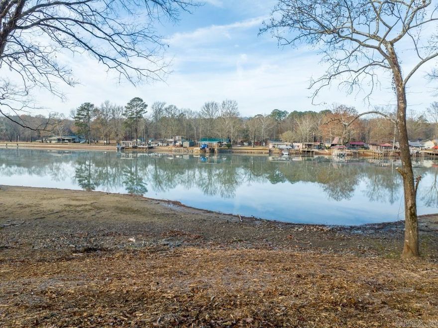 328 feet of shoreline on The Main Channel of Lake Hamilton under 500??? 1.85 Acres will allow for Two Single Family Homes.  This is a secluded lot surrounded by many gorgeous trees, plants, and flowers.  Come and enjoy the beautiful scenery from the extensive shoreline. Survey on file. Please call today for a showing.