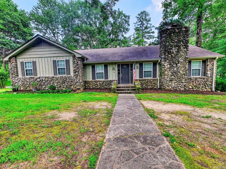 ***Beautiful home on corner lot in a highly desired, established neighborhood*** Upstairs offers 2,248 SF with 4 bedrooms  including the primary suite, guest bath and half bath. The spacious kitchen features custom floor-to-ceiling cabinetry with built in features and opens to a tiled dining area, laundry room and half bath. Living room boasts a wood burning stove with a gorgeous rock fireplace perfect for the holidays. Hardwood floors flow through the main living space, hallway and first bedroom. The primary suite includes a private deck overlooking the wooded yard and terrace below. Downstairs, the walk-out basement adds 1,312 SF with a large living area, 2 bedrooms, and a full bath—ideal for a second kitchen, multigenerational living, or rental income. The 2-car garage has abundant storage with shelving and 2 large storage rooms. Exterior showcases natural rock and painted wood siding that blends with the surrounding mature trees. Architectural shingle roof, gutters, French drains, newer windows, 2 HVAC units and thoughtful updates throughout make this home move in ready.