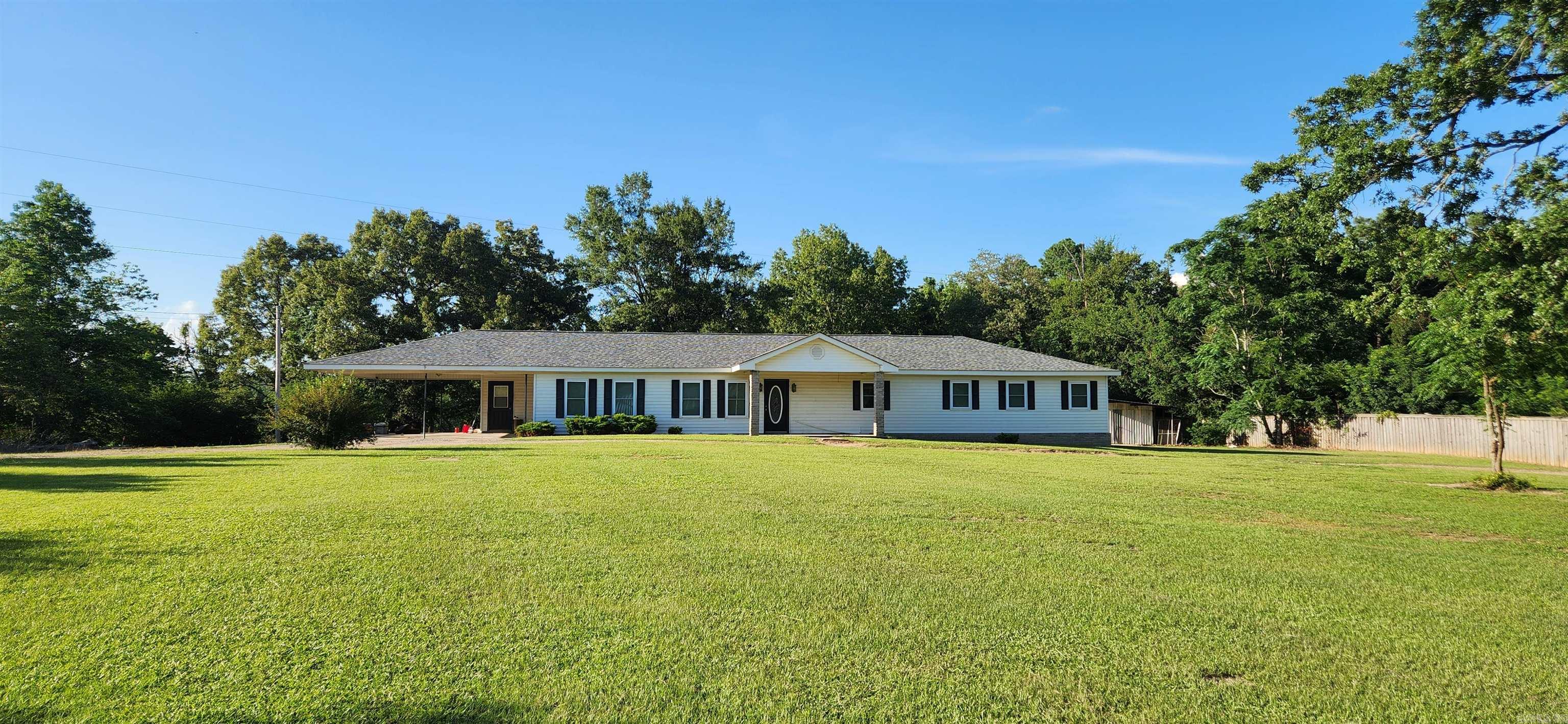 This spacious 3-bedroom, 2-bathroom home offers comfortable country living just minutes from town. The open-concept living, kitchen, and dining area features beautiful, durable woodgrain tile flooring installed in December 2024. The large primary bathroom was renovated in November 2024 and now includes a walk-in shower and a separate tub. All bedrooms are generously sized and include large closets, with an additional room converted into an expansive walk-in closet—perfect for extra storage or wardrobe space or 4th BEDROOM. The laundry room is conveniently located off the kitchen and includes ample shelving, making it ideal for use as a pantry as well. Additional updates include a new HVAC system (interior and exterior) installed approximately four years ago and a brand-new roof added in 2024. Outside, the home includes a double carport, a small storage shed, and sits on 2 serene acres, offering peaceful country views with the convenience of nearby town access. Huge front yard!!