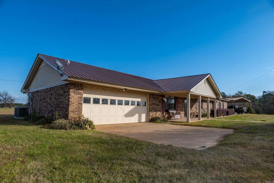 Welcome to this expansive 3200+ square-foot ranch home, thoughtfully designed for comfort, entertainment, and practicality. The open floor plan greets you as you enter, seamlessly connecting the spacious living areas for easy communication and flow. A cozy fireplace serves as the centerpiece of the large living room, which also includes an entertainment area perfect for gatherings or relaxing evenings. The open dining area connects to the kitchen, allowing you to stay engaged with guests or family while cooking. This home is built for both convenience and style, featuring two separate laundry rooms, one of which is located off the massive master suite. The master suite also includes a 10x12 office space a versatile room that could easily be used as a bedroom. With three additional spacious bedrooms and an updated interior, this home offers plenty of room for the entire family.  The 107 acres of well-maintained pasture or hay ground are a rare find, offering perimeter fencing for rotational grazing and highly productive hayfields.