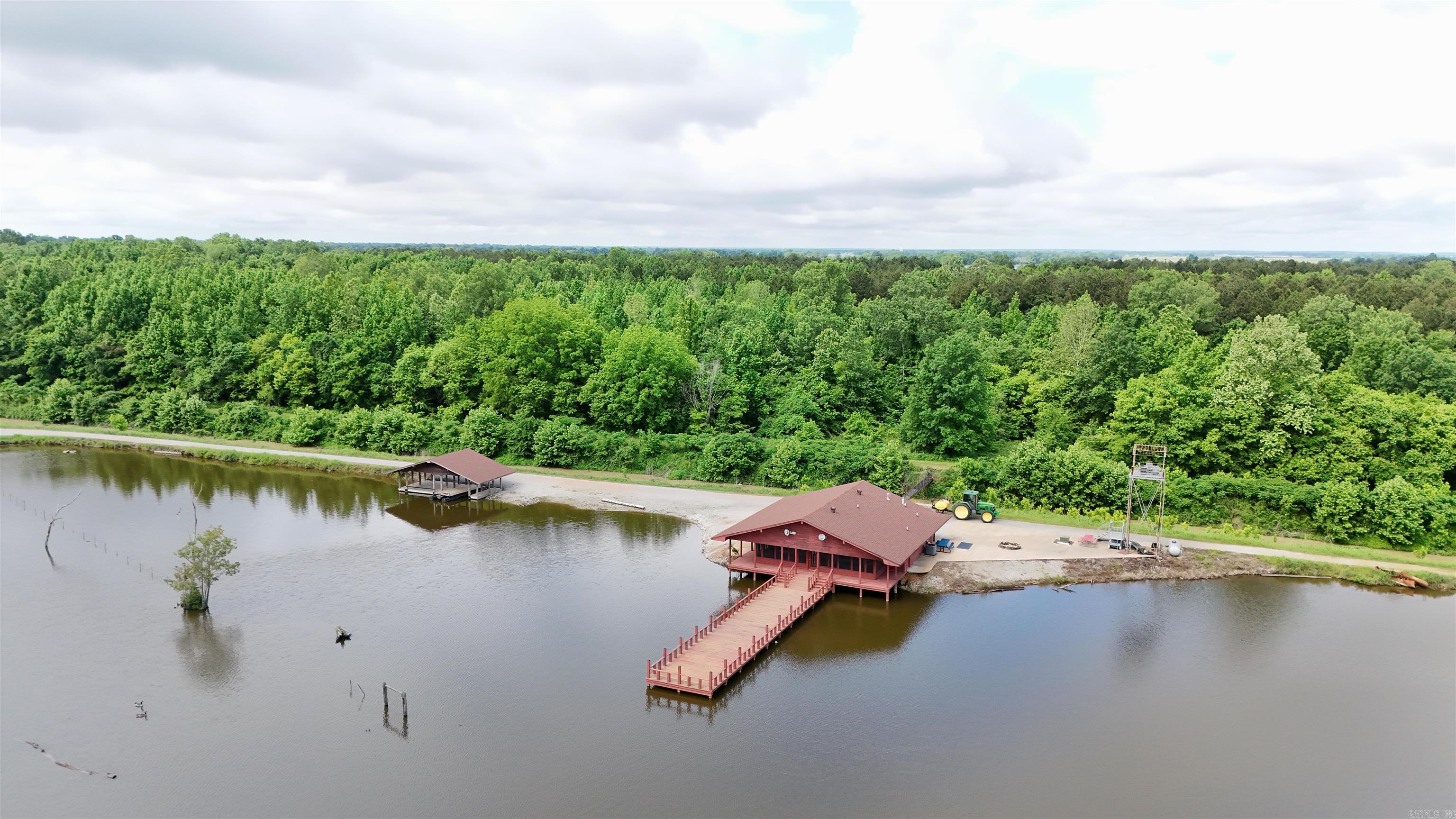 I am pleased to bring you one of the most diverse tracts in Northeast Arkansas. This is truly special place that feels like a small WMA. Known to most as a "Long Pond'', this tract is the very definition of a sportsman’s retreat. Multi-generations of the same family have enjoyed and made memories at this haven. Trophy bass fishing, duck and deer hunting and of course small game, can all be enjoyed in abundance on this unique tract. Gated entrances take you through bottomland hardwoods and planted pines to arrive at the lodge overlooking a stocked lake with multiple docks and a boat house. Moist soil units and floodable timber with blinds, watered with two wells, help establish it as waterfowl destination place. Food plots and deer stands are scattered throughout and the trail system makes traveling around a breeze. Improvements are constantly and currently being done to enhance even more. A written description just doesn’t do this property justice. To understand a property of this magnitude you must see it for yourself. Please call Chris at 870-819-7306 for a private showing. Lodge with full utilities Outdoor cooking area and dock overlooking the lake Boat House Multiple Docks