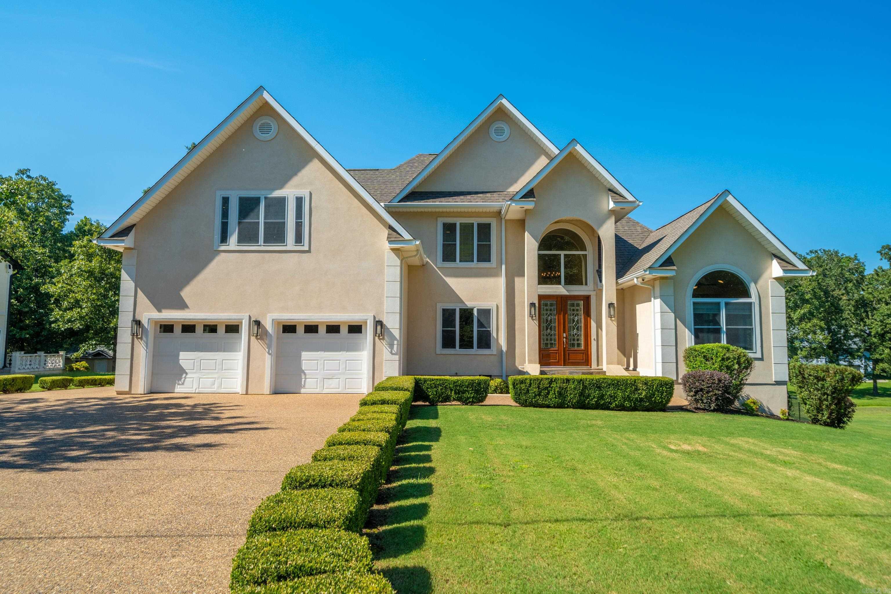 Welcome to this spacious 4-bedroom, 3.5-bathroom home in the desirable Lake Hamilton School District. Built in 2006 and offering 3,346sq ft of living space, this property is designed for both comfort and functionality. Step inside to find beautiful cherry hardwood floors, soaring ceilings, built-in cabinetry, and a cozy, new electric fireplace insert in the living room. The floor plan features a formal dining room plus a casual eat-in kitchen, perfect for gatherings of any size. Fresh paint throughout and new carpet in all bedrooms give the home a move-in-ready feel. The HUGE primary suite is a true retreat with two walk-in closets, a double vanity, jetted tub, and separate shower. Upstairs includes a bonus room offering flexible space for work, play, or guests. Additional highlights include a new roof in 2022, a central vacuum system, a storage area under the home with a full-size door, and a two-car garage plus extra parking pad. Enjoy the outdoors on the new deck with iron railing, overlooking the .49-acre lot. As part of the subdivision, youāll also have lake access with a private boat launch, making this the perfect home!