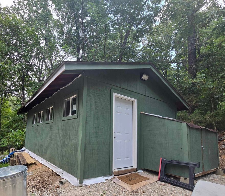 Located in the quiet Hidden Valley area of Highland, this cozy and functional cabin offers a unique opportunity for privacy and potential. Set on a low-traffic road with no nearby neighbors, the property provides a peaceful, tucked-away setting ideal for those seeking a more secluded lifestyle. The cabin features a living area, kitchen, and a bathroom complete with a shower and toilet. It is currently livable and in working condition, while the unfinished interior allows for customization to suit your style—whether you’re envisioning a simple rustic retreat or a more polished finish. Heating is provided by a propane heater, and cooling is handled with a portable air conditioning unit. The property also includes the remains of a previous home’s foundation, offering additional possibilities for future building or expansion. With a little vision, this property has the potential to become a great weekend getaway or full-time residence.