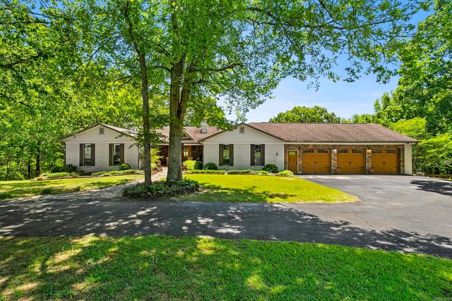 Sitting on 17 gorgeous acres just outside of Searcy, this spacious 5800+ sq ft custom estate offers a perfect balance of craftsmanship, privacy and comfort! This home features 5 bedrooms with 2 of the guest rooms & a full bath on the main level with the updated primary suite which has faulted ceilings with a wooden beam, access to back deck, walk-in shower, updated vanities, lavatory, & huge walk-in closet. The basement has 2 guest rooms with a full bath between, great family room with stone fireplace, safe room, & large utility room for laundry, crafts & storage of all your things! The main level also boasts a lot of natural light, two living rooms, formal dining room, breakfast room & hearth room for cozy mornings by the fire! The kitchen features a double oven, 6-burner gas cooktop, quartz countertops & a breakfast bar. Spend hours outside on the amazing deck with gas fire pit, covered outdoor kitchen with gas grill, fireplace, & wood-fired pizza oven! Great home with endless entertaining and hosting potential both indoors and out! Don't forget the 3 car garage with a spacious storage room/shop that runs the length of it! Make this truly peaceful retreat your home today!