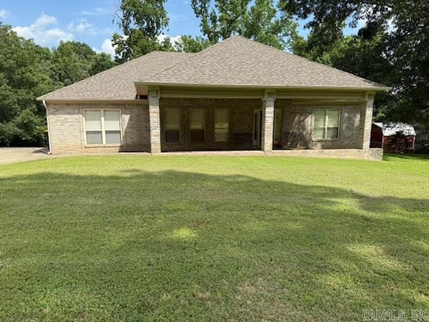 If you’ve been dreaming of space, privacy, and a home that feels both cozy and functional — this is it. This beautiful 3-bedroom, 2-bath home sits on a full acre, offering room to breathe while still feeling welcoming and connected. The open floor plan is perfect for everyday living and entertaining. The family room features a tray ceiling and a stunning rock gas fireplace that creates a warm, inviting focal point. The kitchen offers a large breakfast bar, tile backsplash, and a brand-new stove, and the oversized dining area showcases a rock accent wall and flows seamlessly into the living room. You’ll love the crown molding throughout, abundant storage, and thoughtful details. The spacious primary suite includes a walk-in shower, jetted tub, large walk-in closet, and direct access to the laundry room. Laminate flooring in the bedrooms adds warmth and durability.  Outside, enjoy a tiered deck, wooded backdrop for added privacy, a large storage building with a metal roof, and gutters already installed.