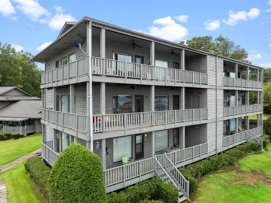 Panoramic views of Lake Hamilton allow you to enjoy sunrise AND sunset on the wrap around deck. 1360 sq ft make this 2nd floor 2 bedroom fully furnished condo larger than most other units in Farr Shores. Enjoy easy entertaining from the large kitchen that is open to the freshly painted living room. The primary bedroom has a picture window and access to the deck plus a large walk-in closet a huge en-suite bathroom.  The 2nd bedroom is large enough for a queen bed plus a bunk. Your boat slip is just steps away and there is a PWC dock as well with this unit. Farr Shores allows nightly rentals and has a pool, tennis courts and private boat ramp. Easy drive to Garvan Gardens, Oaklawn, Magic Springs, Bathhouse Row, National Park trails and Mountain Tower