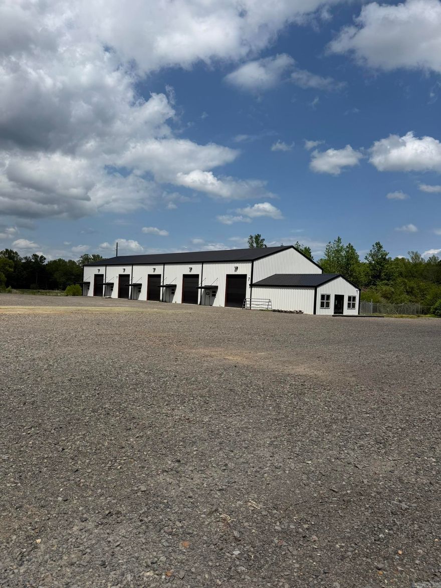 Great investment opportunity with unique and versatile options - New Construction - Multi Purpose Commercial Property with endless potential.  Currently offers approx 30 acres, large pond, (2) 50X100 Commercial Buildings, (1) is climate controlled, each with (5) 30x50 bays, 20X30 front office space, additional upstairs storage or office space and room to grow.  Property also includes, (2) Baseball fields w/infield Turf, concession stand, restrooms chain link fencing, and covered dugouts.  Added bonus is a 3-stall covered barn w/turnout area, tack/feed room and pipe fencing. Minutes west of Downtown Magnolia, this property is a one of a kind.  Contact our office for more details or to schedule a showing.