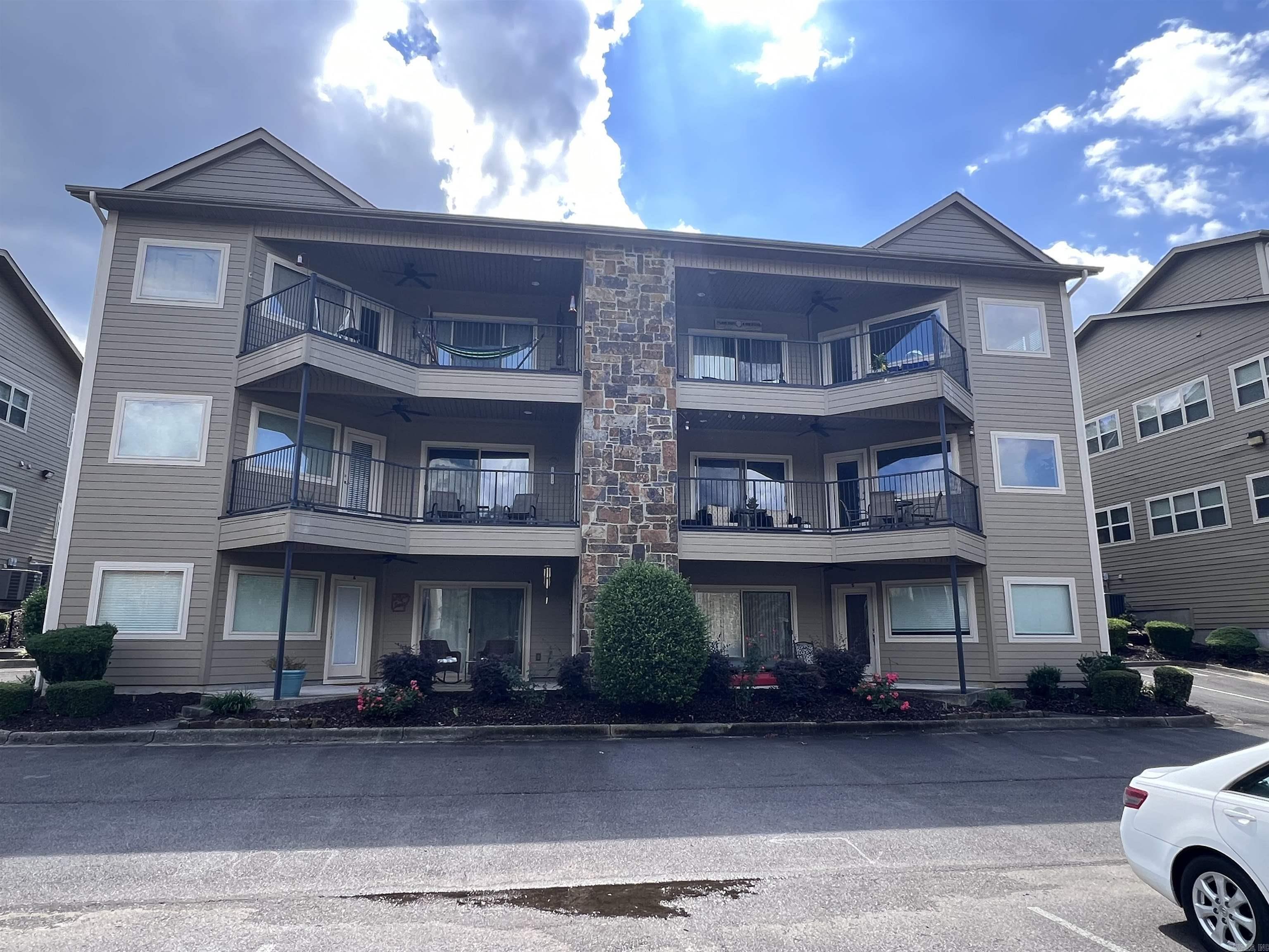 This beautiful 2nd floor condo on Lake Hamilton offers a perfect blend of comfort and elegance. Featuring two spacious bedrooms and two modern bathrooms, the open floor plan invites abundant natural light and fosters a warm, inviting atmosphere. High ceilings add to the sense of openness, enhancing the overall ambiance. Step out onto the balcony to enjoy breathtaking views of the lake, ideal for relaxing with a book or sipping your morning coffee. With its stunning location and thoughtful design, this condo is a true retreat for those seeking lakeside living.