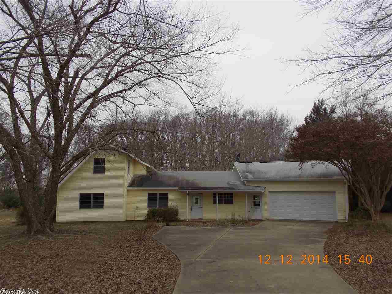 Nice country setting with highway frontage. Huge attached shop/garage. House needs some repairs, sold as is. Lots of room for your family and large eat in kitchen.